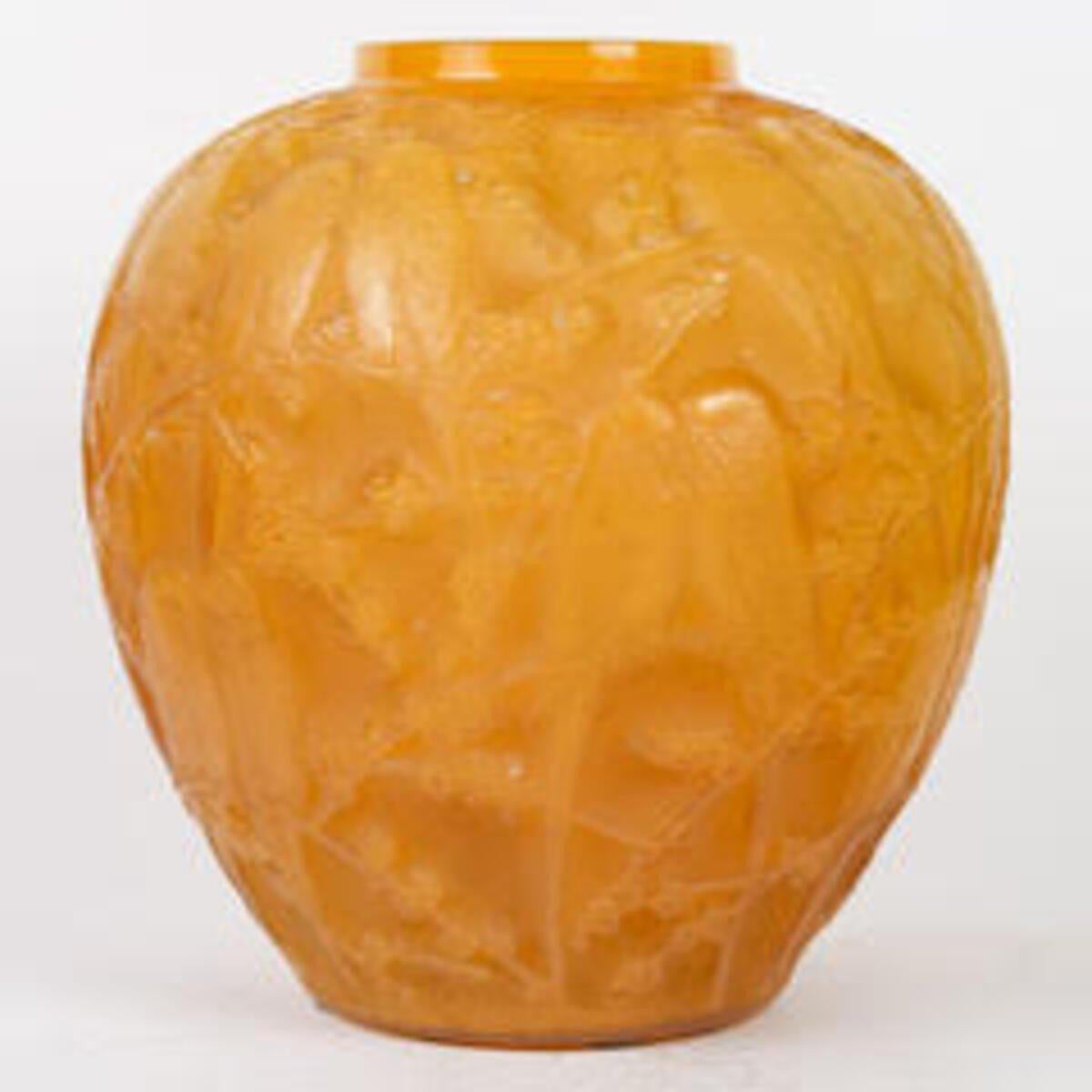 Vase in yellow and opalescent double layer pressed moulded glass called butterscotch.
Created in 1919 and withdrawn from the catalogue in 1937. Signed on the reverse.
Bibliography: Félix Marcilhac, René Lalique - Catalogue Raisonné de l'Œuvre de