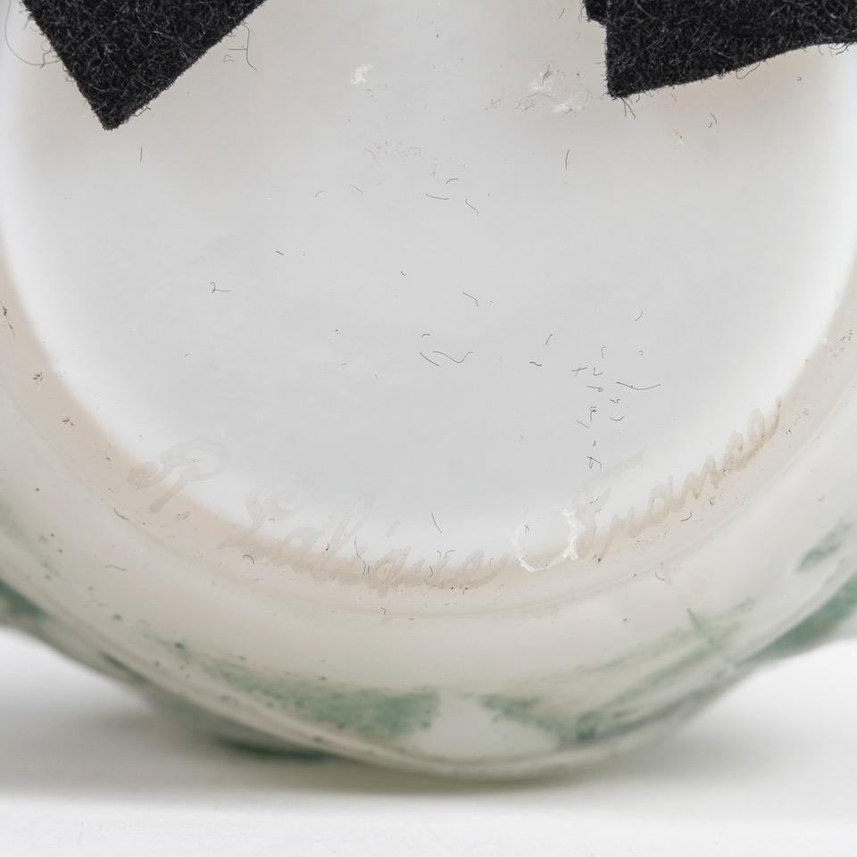 Ronces, created in [1921], deleted from the catalog in 1932, not used again after 1947.
Soliflore-necked ovoid vase.
Height 23.5 cm 
Proof in blown-molded opalescent glass enhanced with an original blue-green patina (ref. Marcilhac 946 page