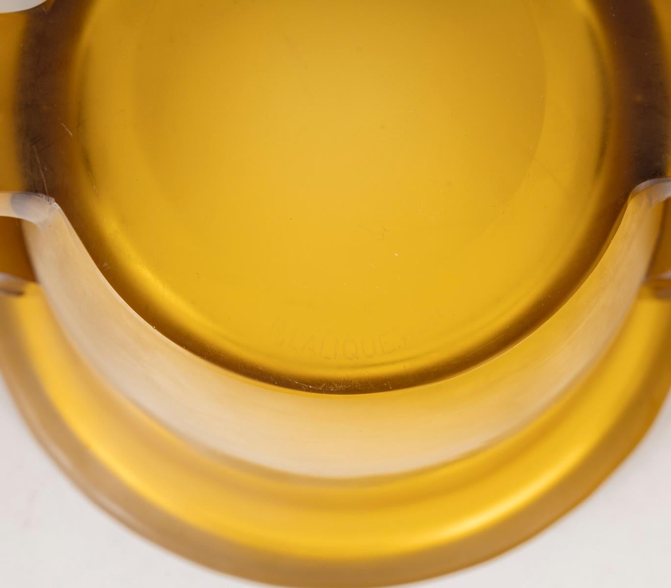 Pierrefonds” vase in pressed molded glass tinted yellow / amber
 designed by René Lalique, created in 1926 with the collaboration of his daughter Suzanne, who created the design. 
Sandblasted signature engraved under the base.
height: 15.5 cm
