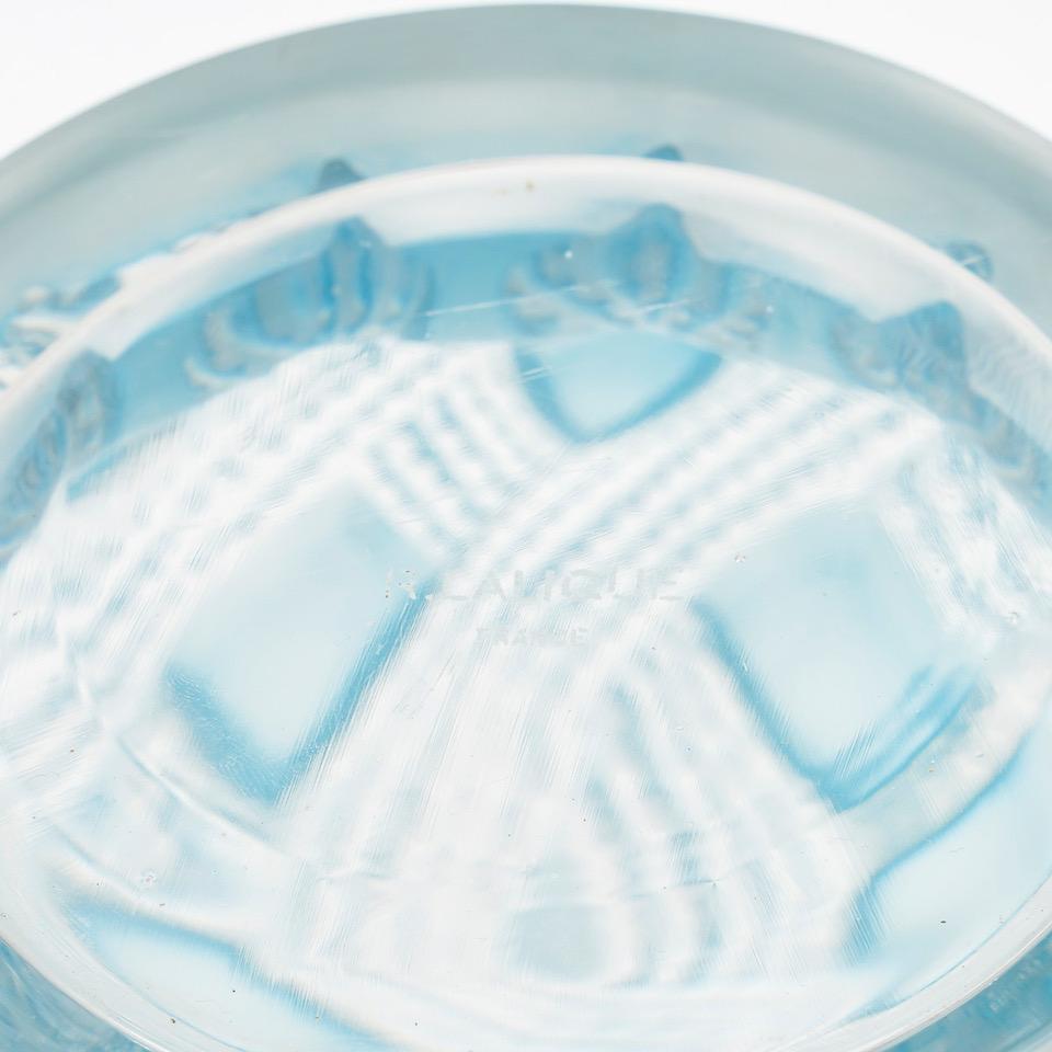 René LALIQUE 

Entrelacs’ vase in pressed moulded white glass with a blue patina.
Acid signature.

Created in 1935 and withdrawn in 1939.

Félix Marcilhac, René Lalique - Catalogue Raisonné de l'Œuvre de Verre, Les Editions de l'Amateur, Paris,