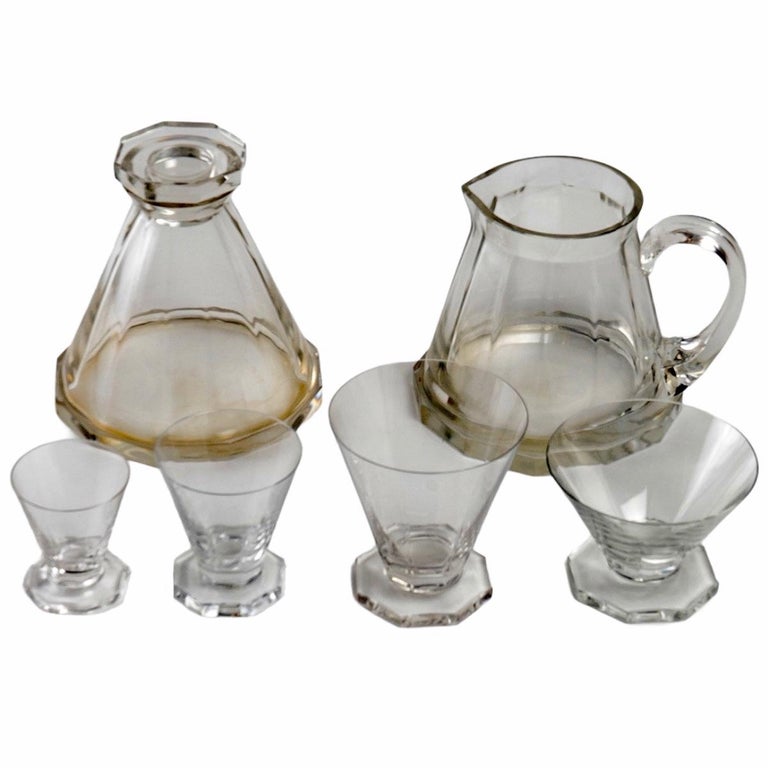 Set of 34 pieces: 32 drinking glasses, 1 pitcher and 1 decanter made by René Lalique in 1935. Model is named 