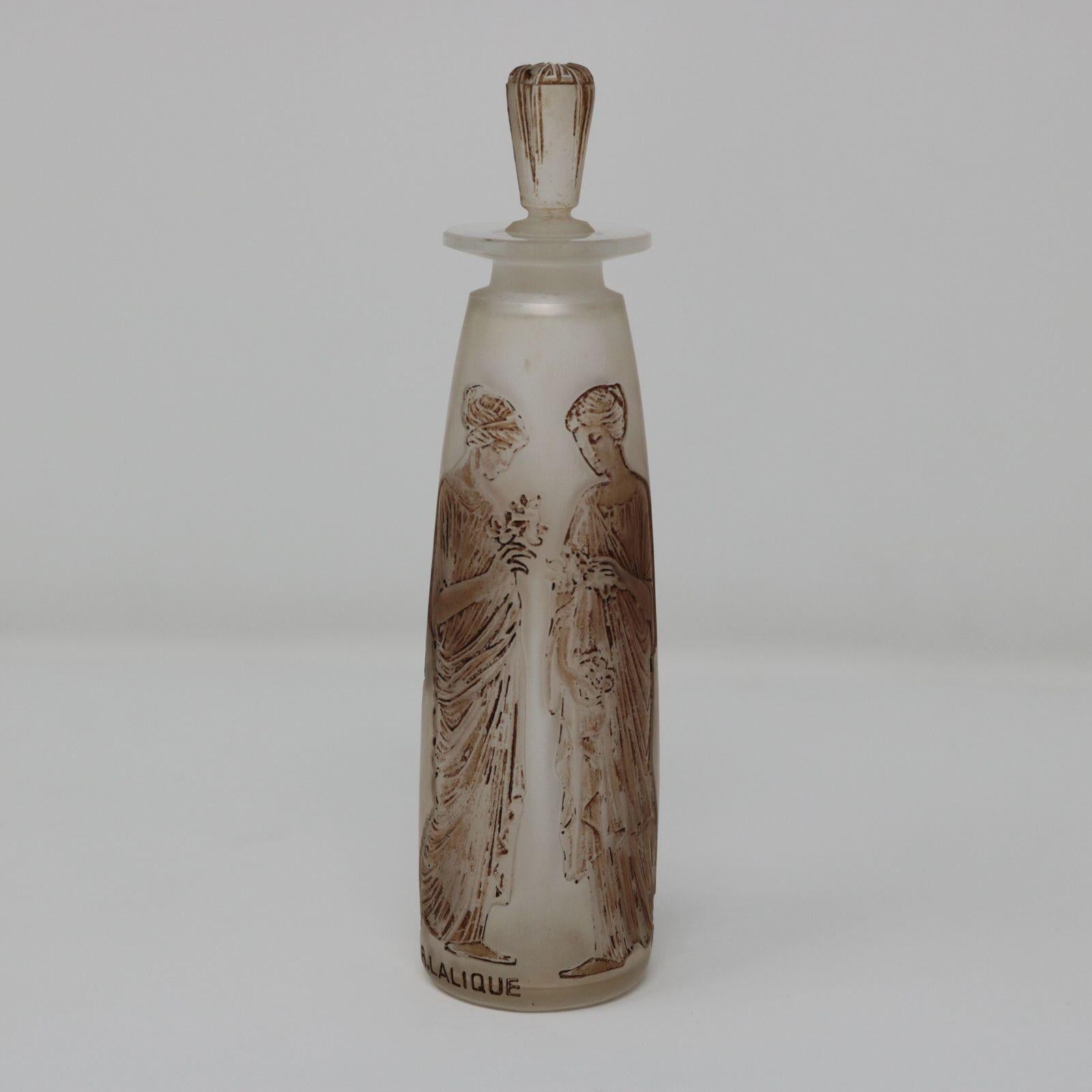 Rene Lalique clear & frosted, sepia stained glass perfume bottle. 'Ambre antique' design. This design features robed maidens, holding flower bouquets. Moulded makers mark, 'R LALIQUE'. Book reference: Marcilhac Coty 3.