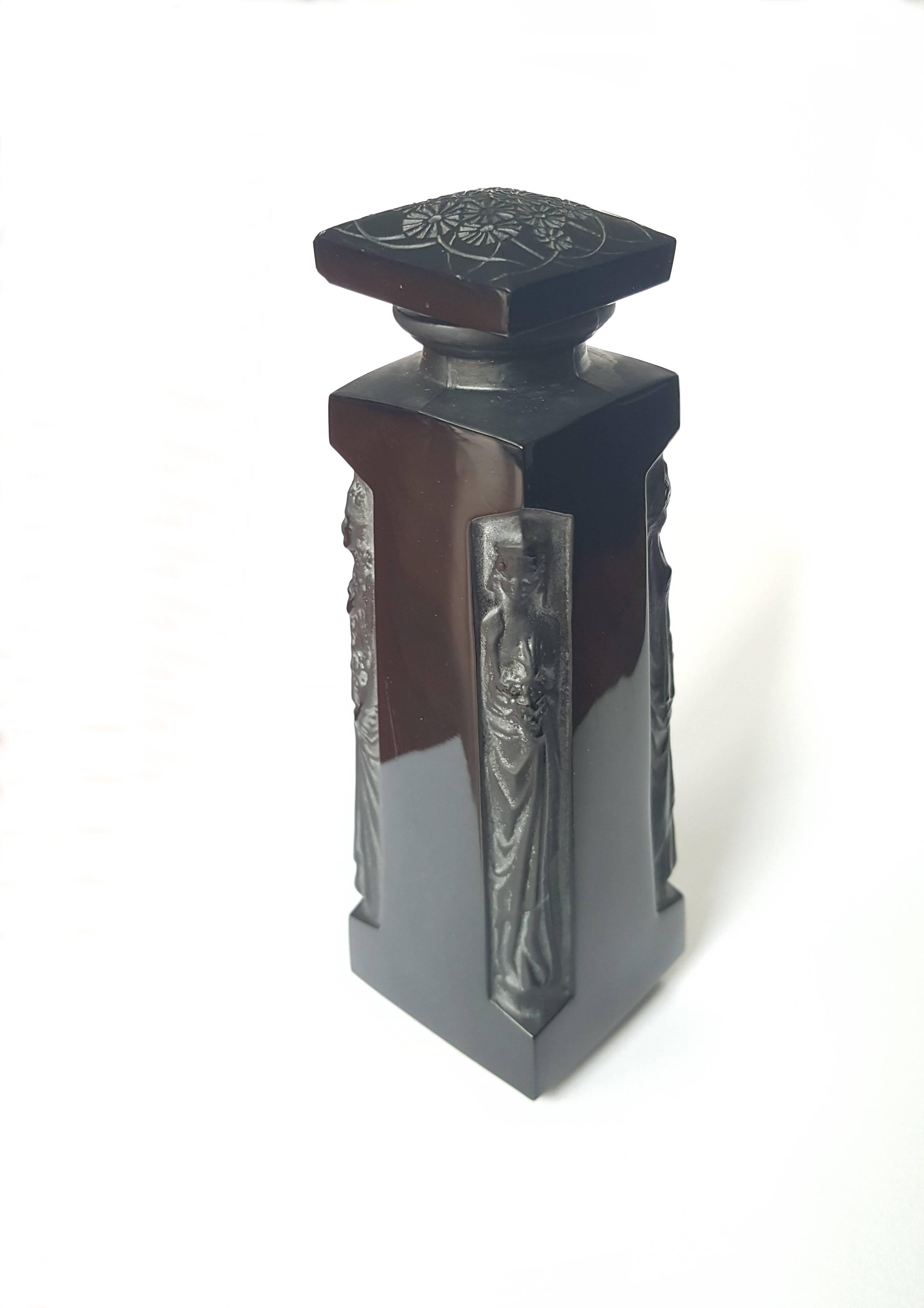 Classic Ambre D'Orsay perfume bottle by René Lalique. Made in black glass with 4 Grecian figures. Floral design on the stopper. Marked at the bottom.
Measurements: Height 5.12 in ( 13 cm ), Width 1.5 in ( 3.8 cm ), Depth 1.5 in ( 3.8 cm ).