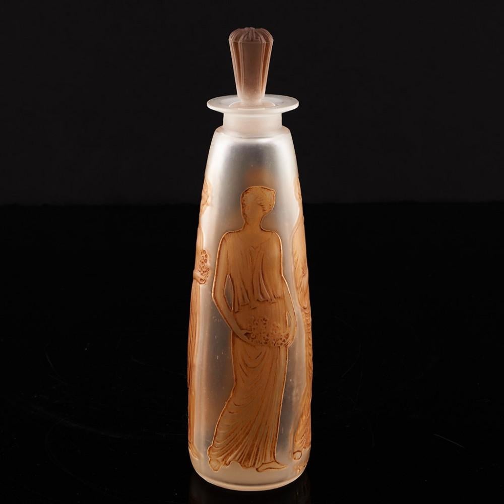 Heading : Rene Lalique Ambre perfume bottle
Date : Designed 1910
Origin : Combs-la-Ville, France
Bowl Features : Tapered form with clear and frosted glass and four amber stained classical ladies.
Marks : Stencilled R Lalique mark with amber