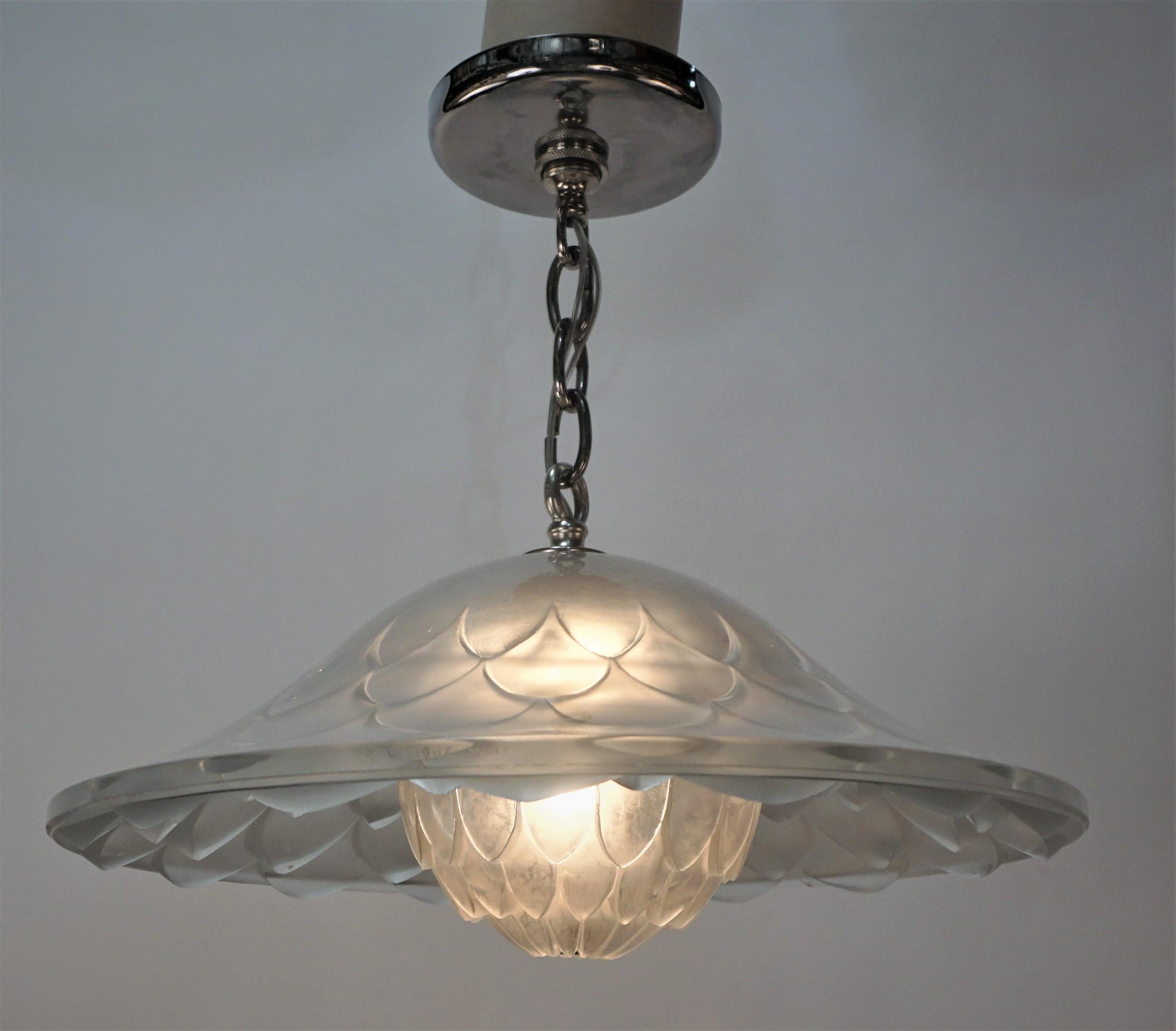 Clear frost glass in a shape of Dahlia with nickel on bronze hardware semi flush chandelier.
Maked Rene Lalique.