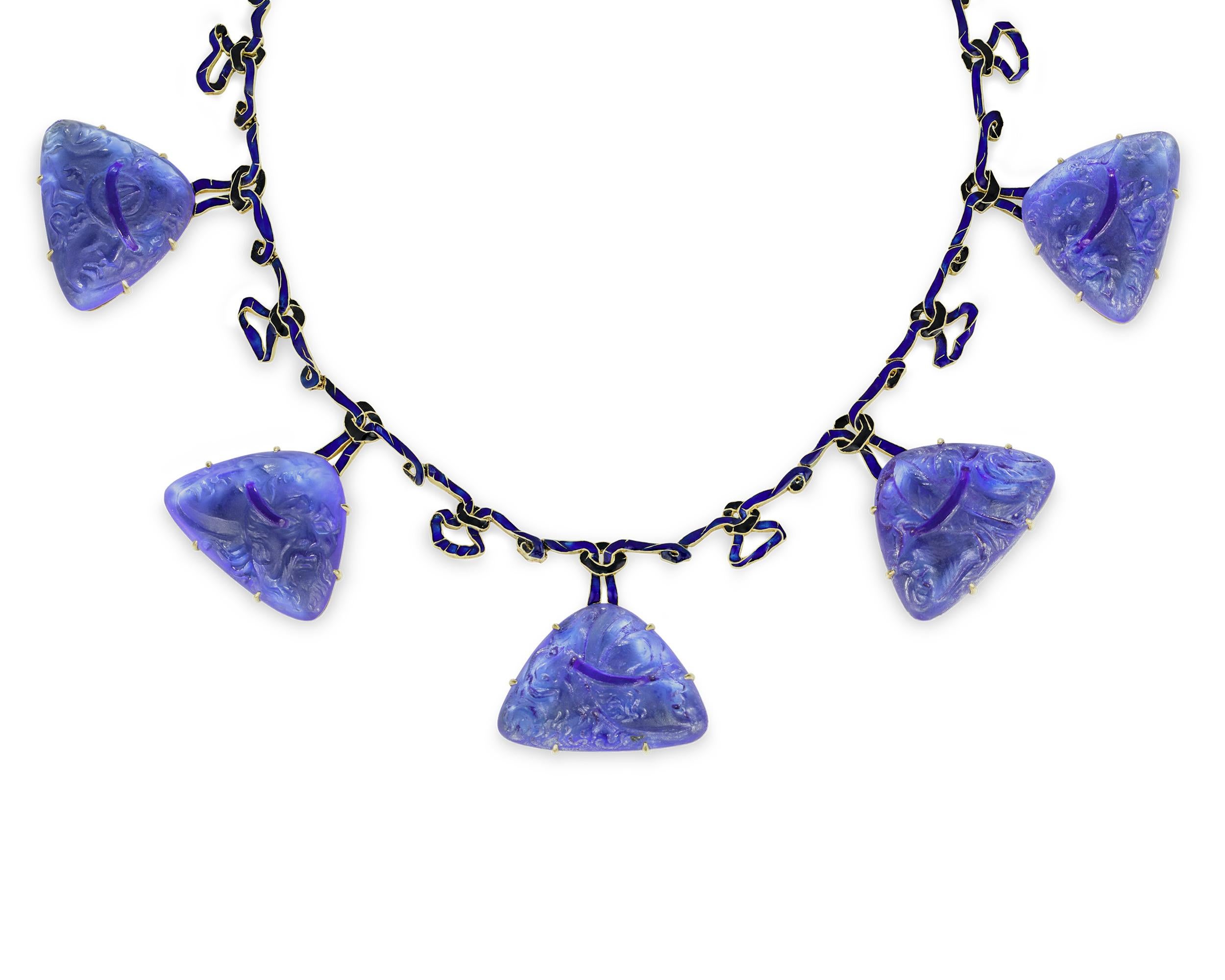 A masterclass in Art Nouveau jewelry design, this stunning glass and enamel necklace is the work of the legendary designer René Lalique. Pendants made of eye-catching cobalt blue glass line the entire length of the necklace. Each displays a