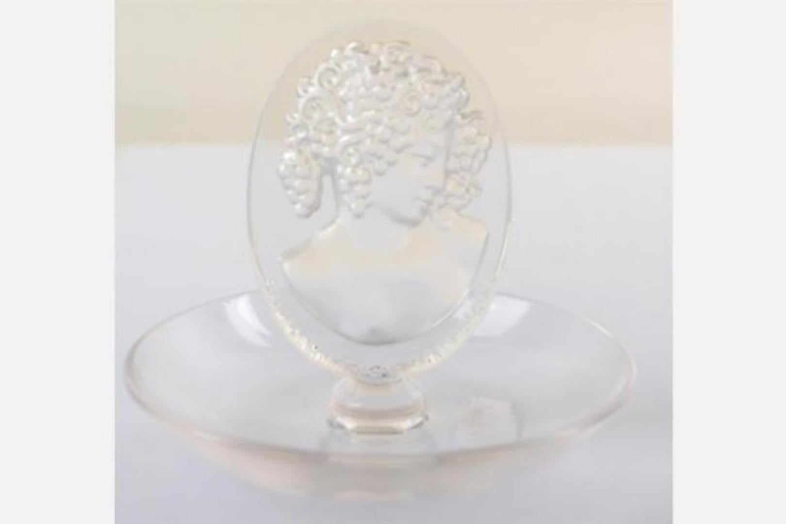 Clear and frosted glass shallow dish form with a central oval plaque of a bust with grapes-on-vines hair and the wording 