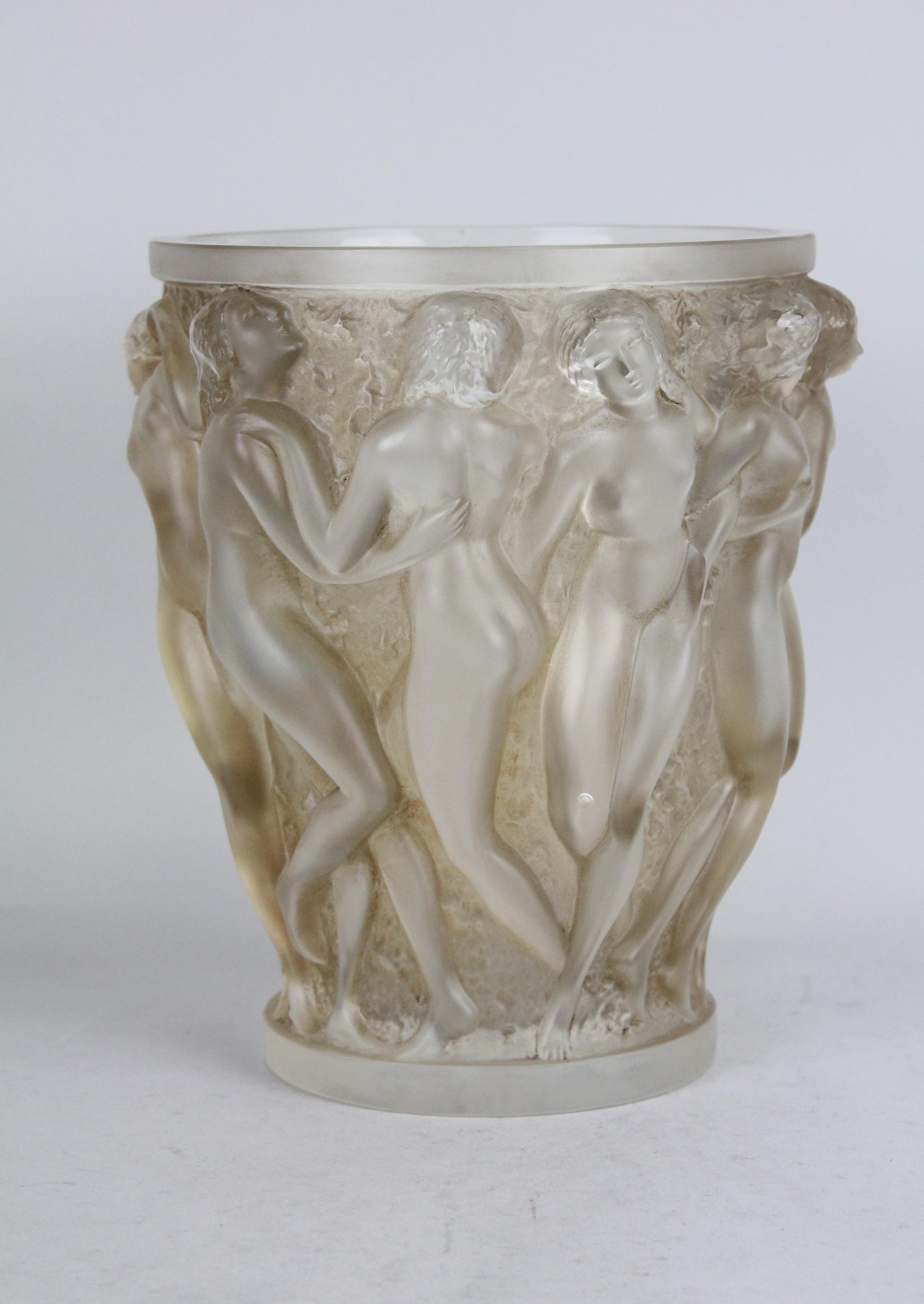 René Lalique Bacchantes vase, design 1927.
This example is clear, frosted, and sepia stained.

The vase is not a newly made reproduction.
It is an early post-war example! 

Litterature: Félix Marcilhac, 