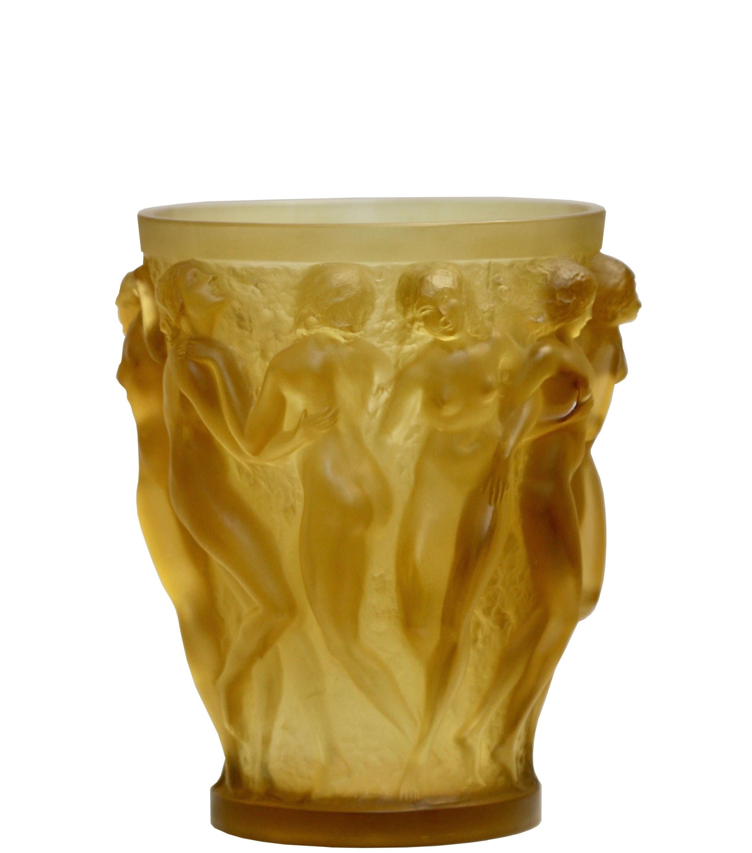 René Lalique (1860-1945)
Bacchantes
Yellow Rene Lalique glass vase with ten female nude figures in high relief on a self illuminating bronze base, cast with stylized oak leaves.
Wheel-carved Rene Lalique France
France, circa 1920
Height 9.5