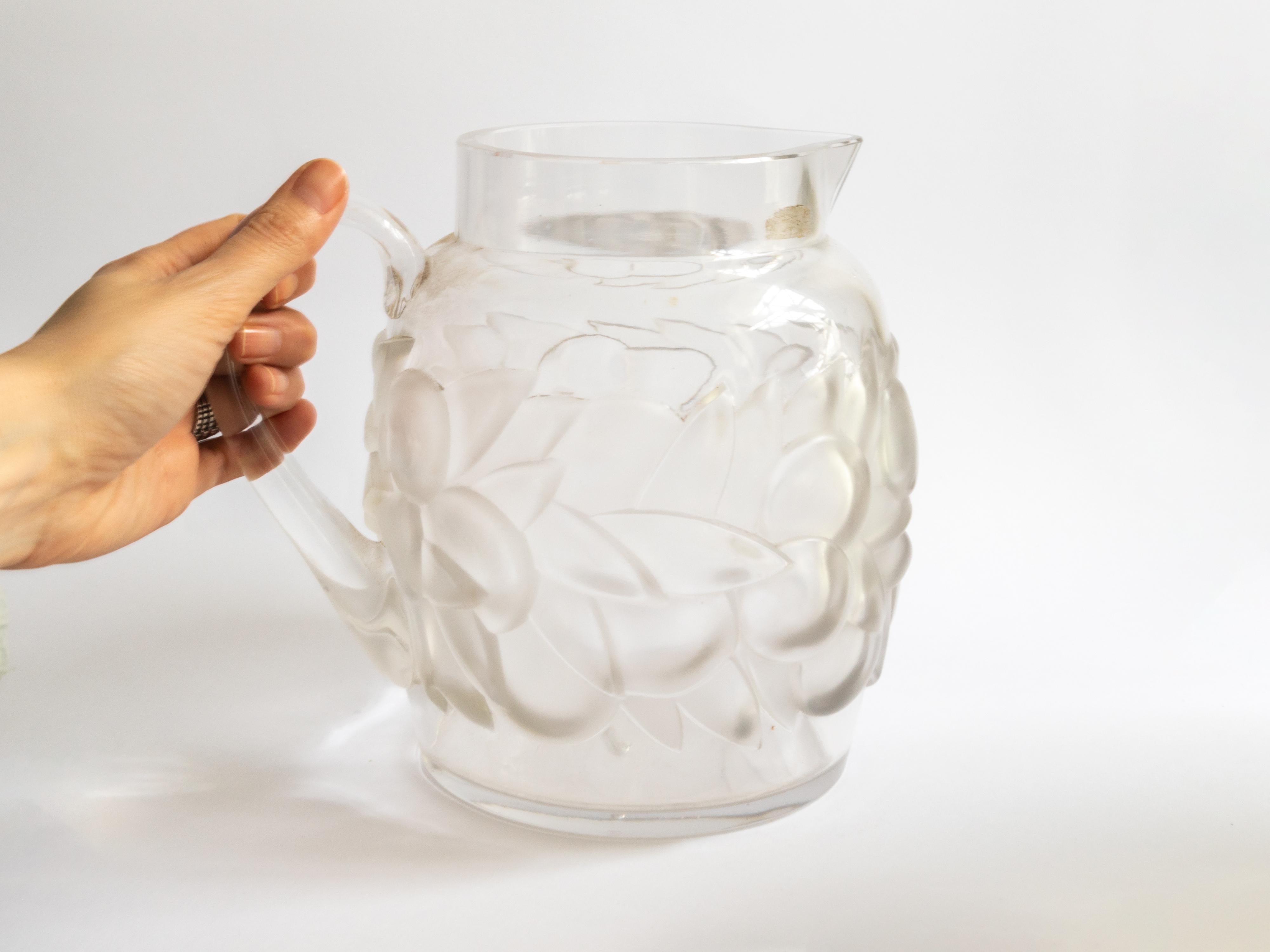 This exquisite orangeade pitcher by René Lalique, model Blidah (no. 3177), showcases the master’s signature opalescent glasswork.

The Blidah pitcher by René Lalique, introduced in 1931, is a distinguished example of Art Deco glassware. This piece