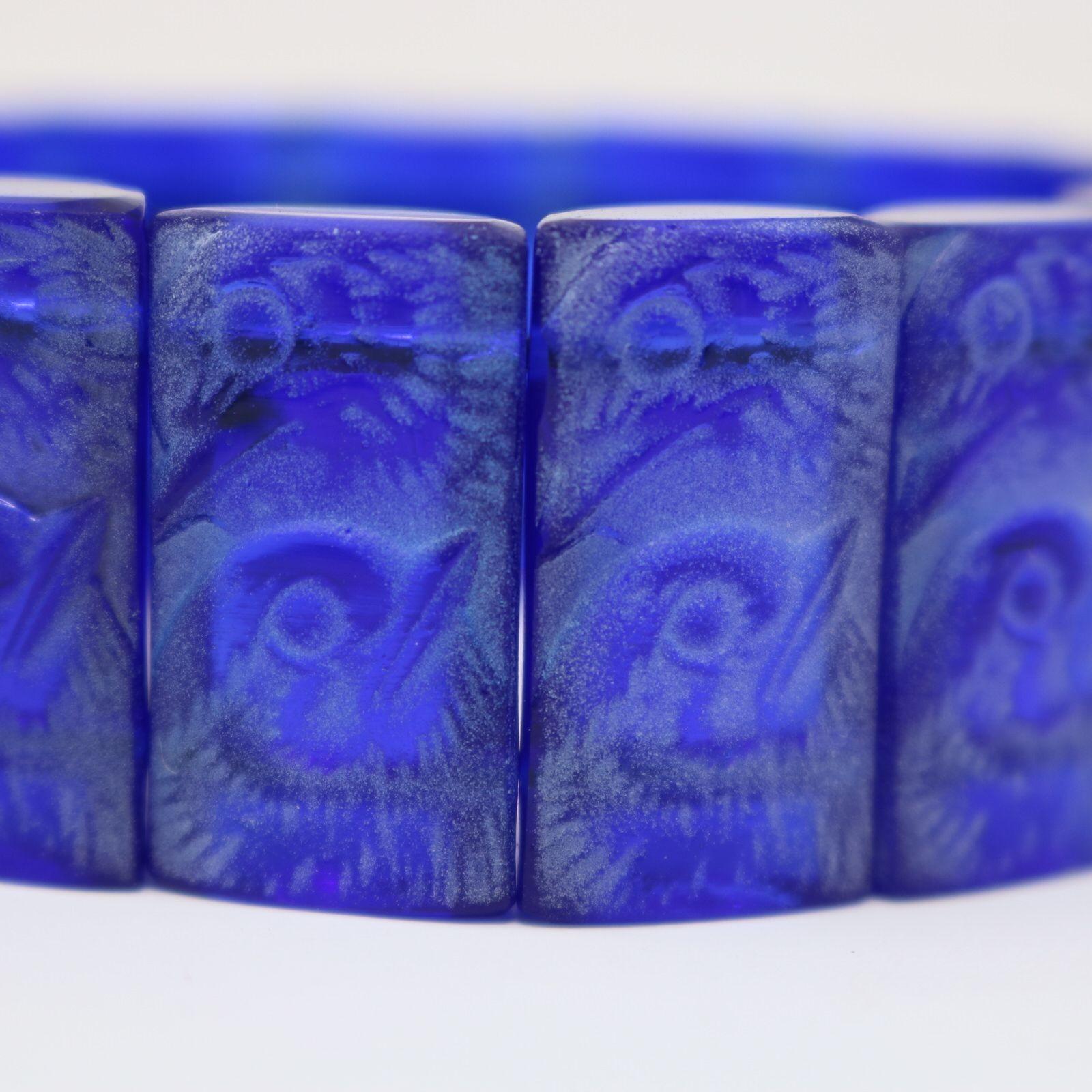 Rene Lalique blue glass with white staining 'Poussins' Bracelet. The bracelet consists of 15 rectangular, cylinder-half shaped tablets, strung together with elastic. Poussins is french for chicks and each tablet has molded chick heads. Engraved