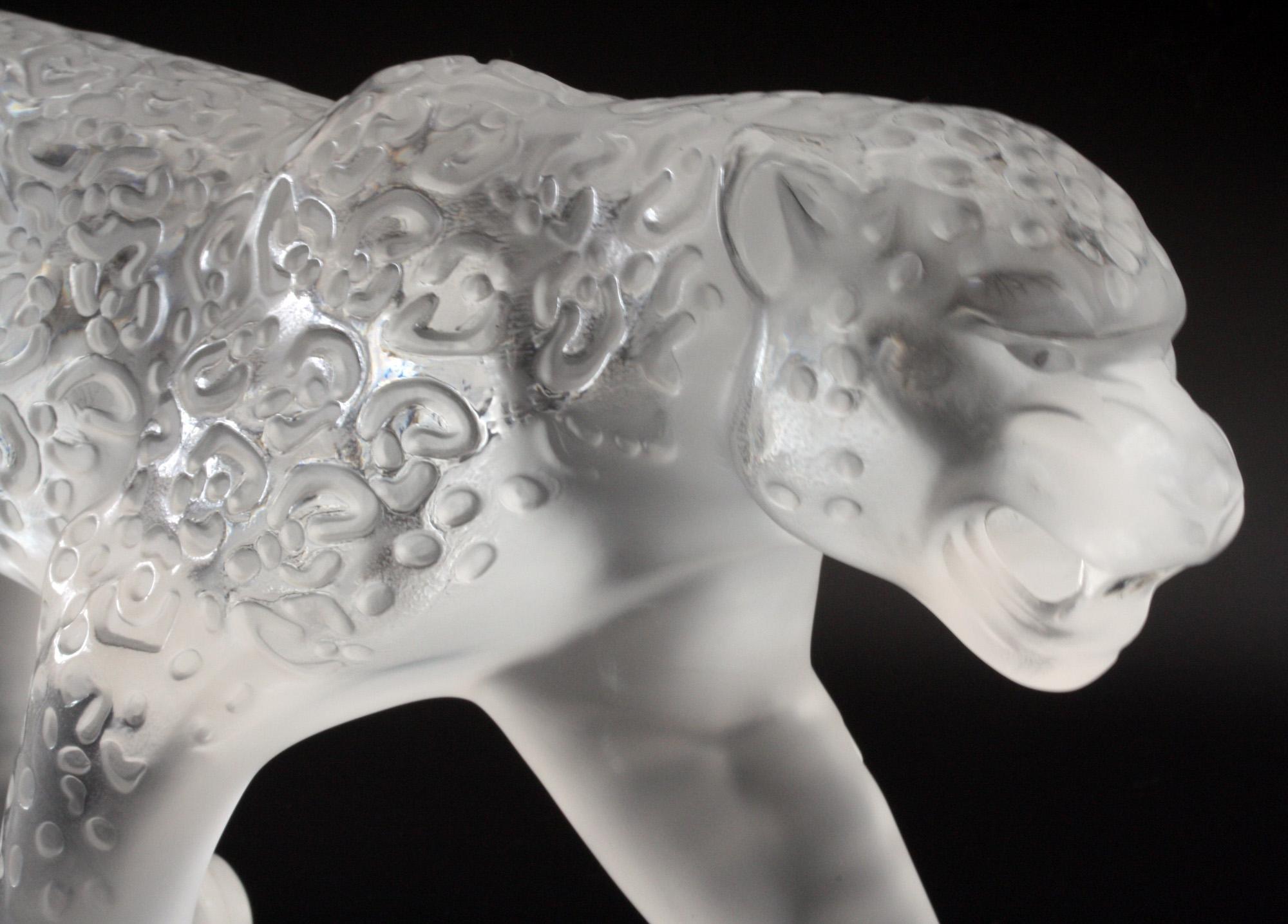 A large and exceptional Lalique art glass figure of a Jaguar cat in clear and frosted glass dating from 1999. The prowling Jaguar has moulded markings to its body with a etched signature mark to one of its back paws. The figure is provided in its