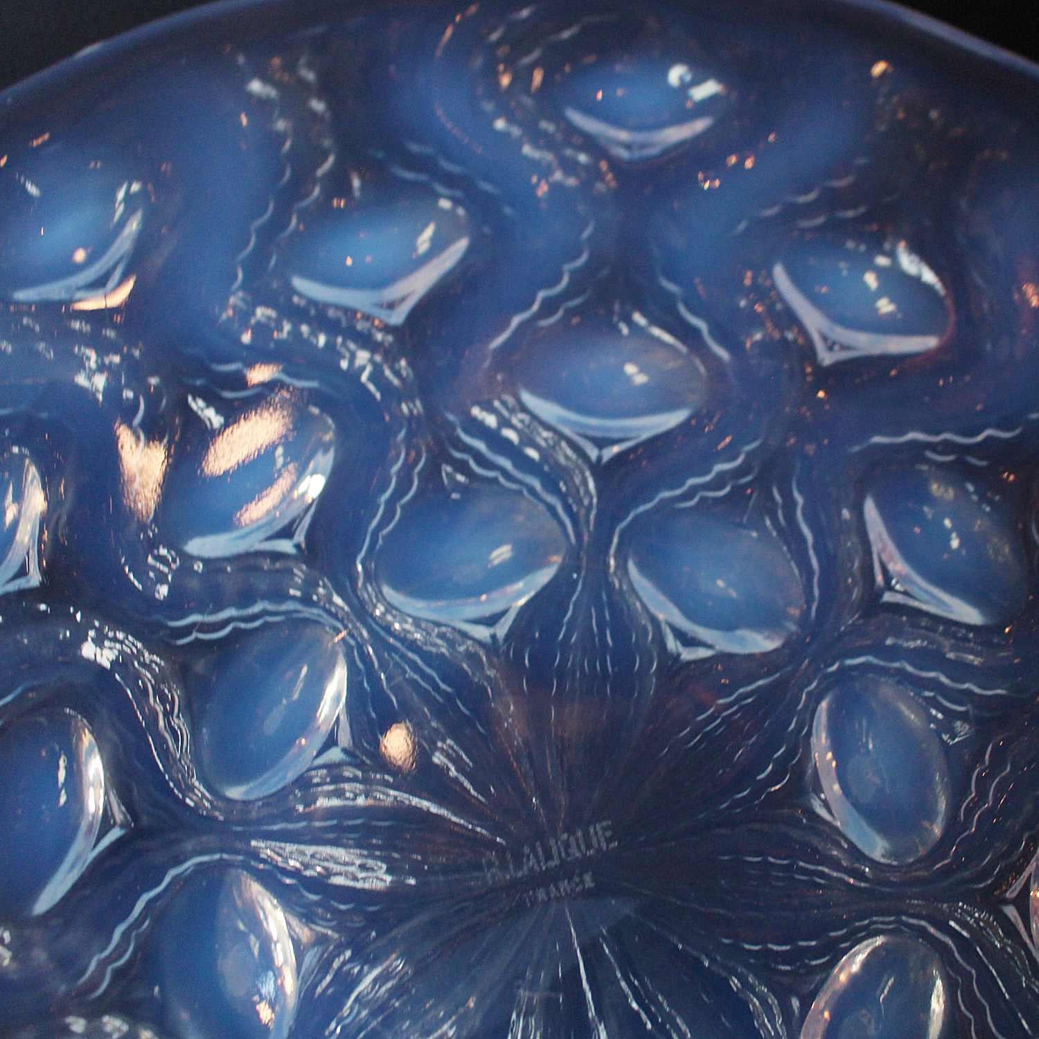 Bulbes no. 2, an Art Deco, opalescent and clear glass coupe bowl. Decorated with radiating pattern of reverse raised stylized flower bulbs. Stencil etched R. Lalique France to underside.
Model no. 3302.
Literature: Marcilhac Catalogue Raisonne de