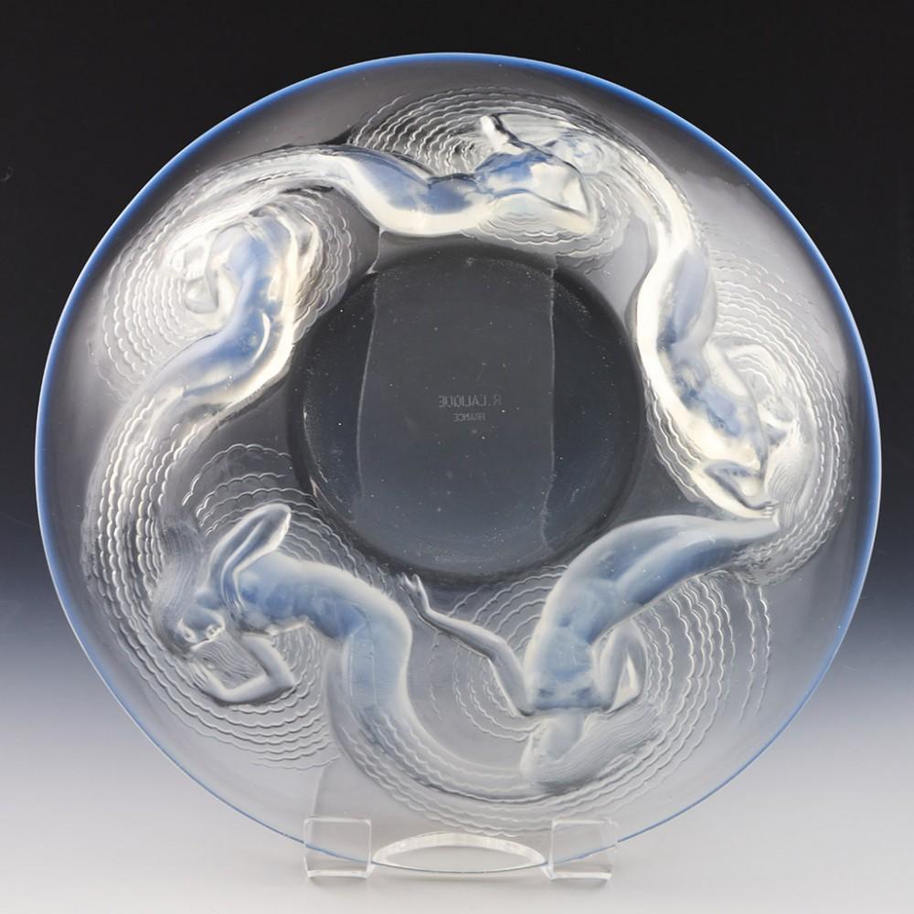 A Rene Lalique Calypso Coupe Ouverte designed 1930 in Alsace, France.
The bowl features five opalescent aquatic nymphs. Acid etched R LALIQUE FRANCE on underside of the base.
Lalique demi-crystal

Additional information: The is inspired by Greek