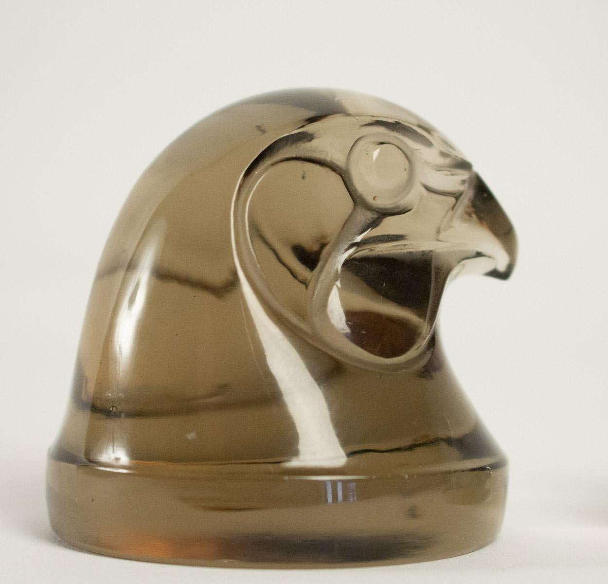 Lalique hawks head mascot in topaz (brown)glass, proper molded signature (R.Lalique France) Model No. 1139, circa 1928 
Sparrow-hawk head mascot signed Lalique France in relief, with two tails on letter Q, in 
model introduced 1928 (discontinued