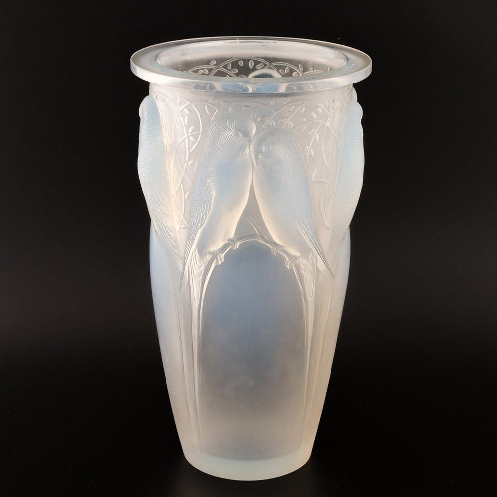 Heading : Rene Lalique Ceylan vase
Date : Designed 1924
Origin : Wingen-sur-Moder. France
Bowl Features : Four pairs of ‘peruches’ perched on branches. Excellent blue opalescence within the birds
Marks : Incised R Lalique France
Type : Lalique