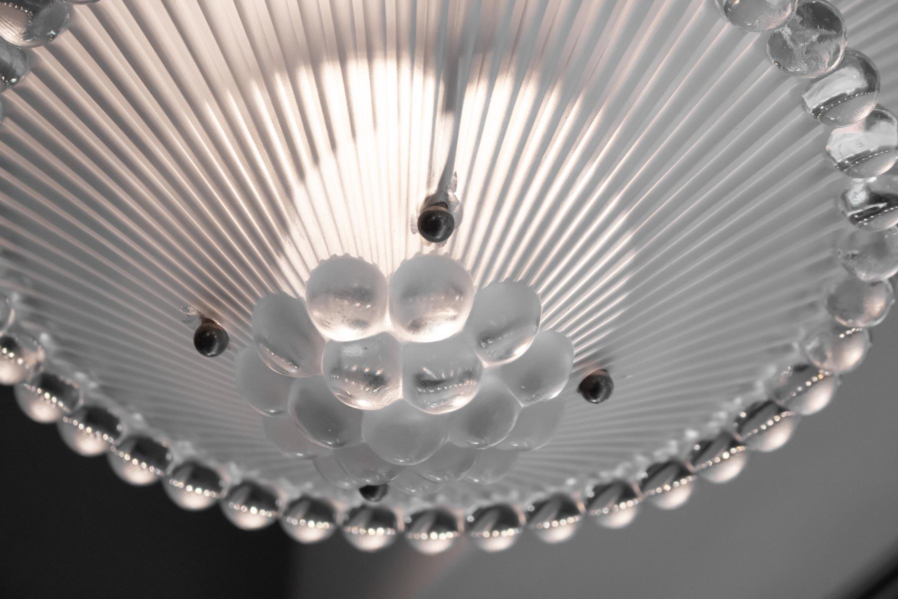 Rene Lalique chandelier Perles: 45 centimeters diameter at the widest part, with two hanging levels of glass and a matching large ceiling cap and cylindrical cover for the bar or rope holding the lower section with ribbed centre section to each
