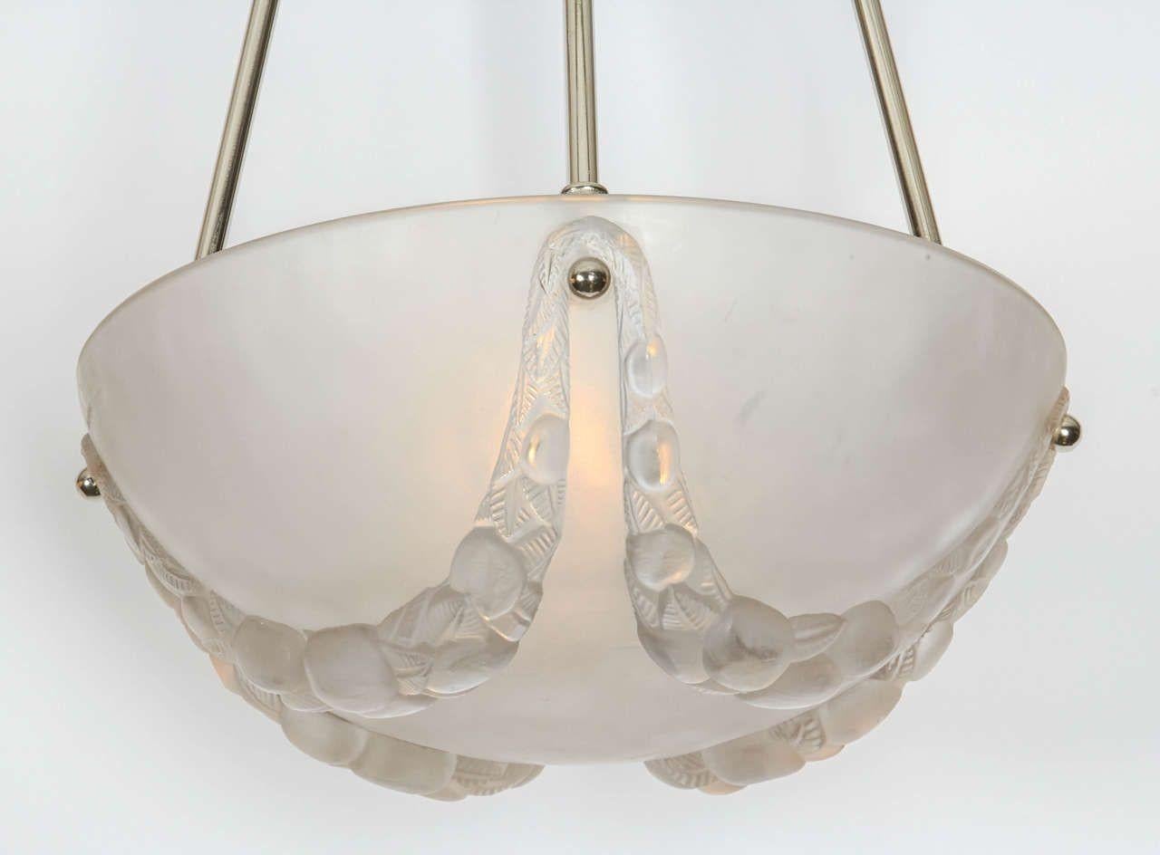 Clear and frosted glass chandelier by Rene´ Lalique.
The 12.25? glass bowl suspended by four new nickel-plated rods with a nickel-plated canopy.
As an alternative it can be mounted flush on the ceiling.