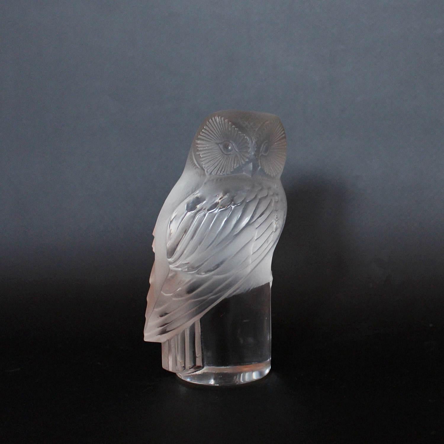 Chouette, an Art Deco glass paperweight. A frosted and clear glass paperweight in the form of a curious owl set over a clear glass base. Model no. 1193 . Literature: Marcilhac, R Lalique Catalogue Raisonné de L’Œuvre de Verre p.391

Stencil etched