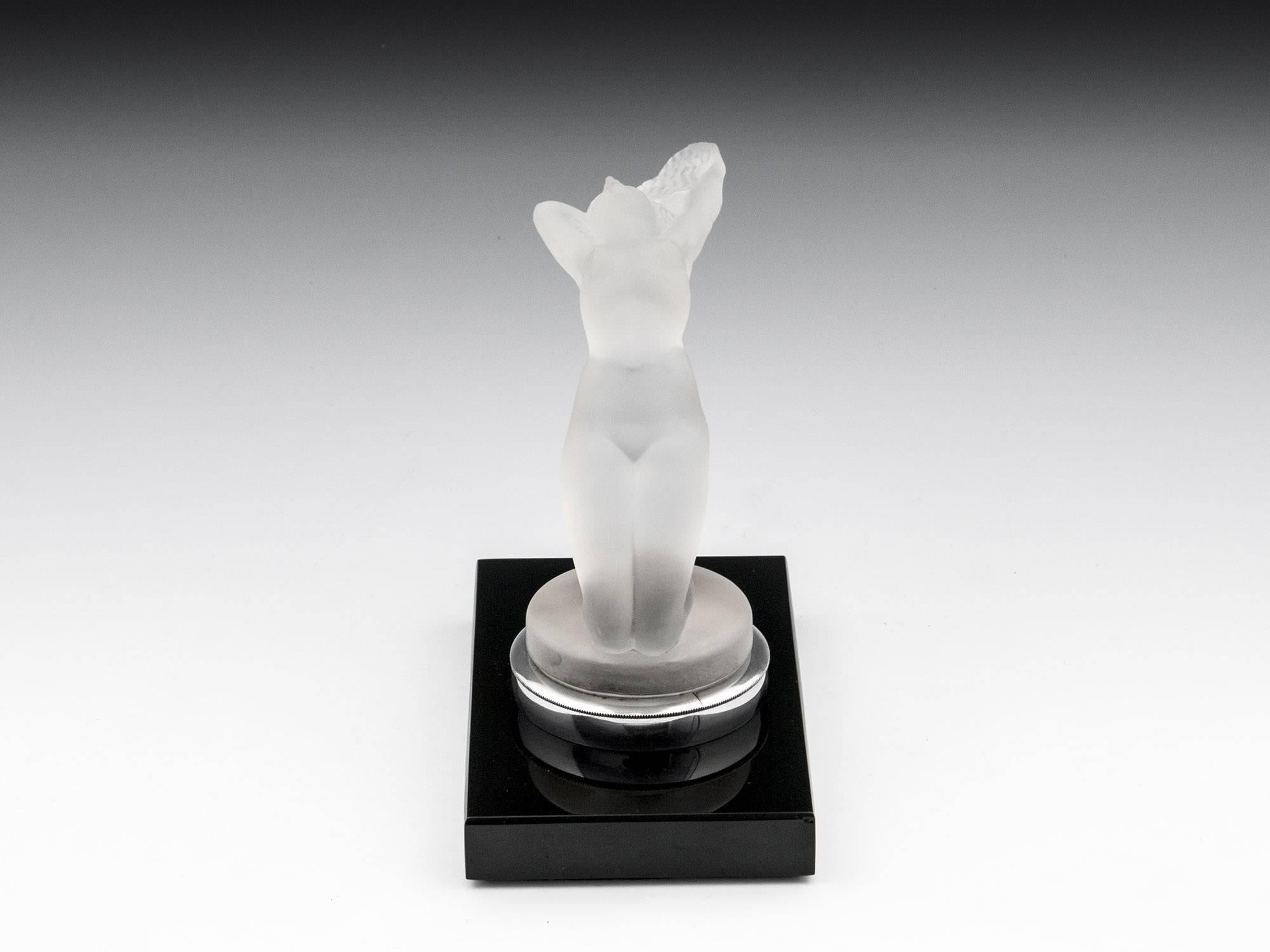 Rene Lalique Chrysis ‘female nude’. Model number 1183. Mounted on a factory fitted Lalique book end mount. Signed in stencil “R Lalique“ to the front of the mascot base.