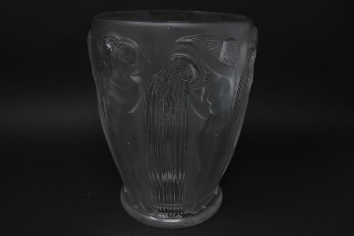 Rene Lalique Clear and Frosted Glass 'Danaides' Vase. This pattern features the Daughters of Danaus stood pouring water from a vessel. Molded makers mark, 'R. LALIQUE', to the underside. Book reference: Marcilhac 972.