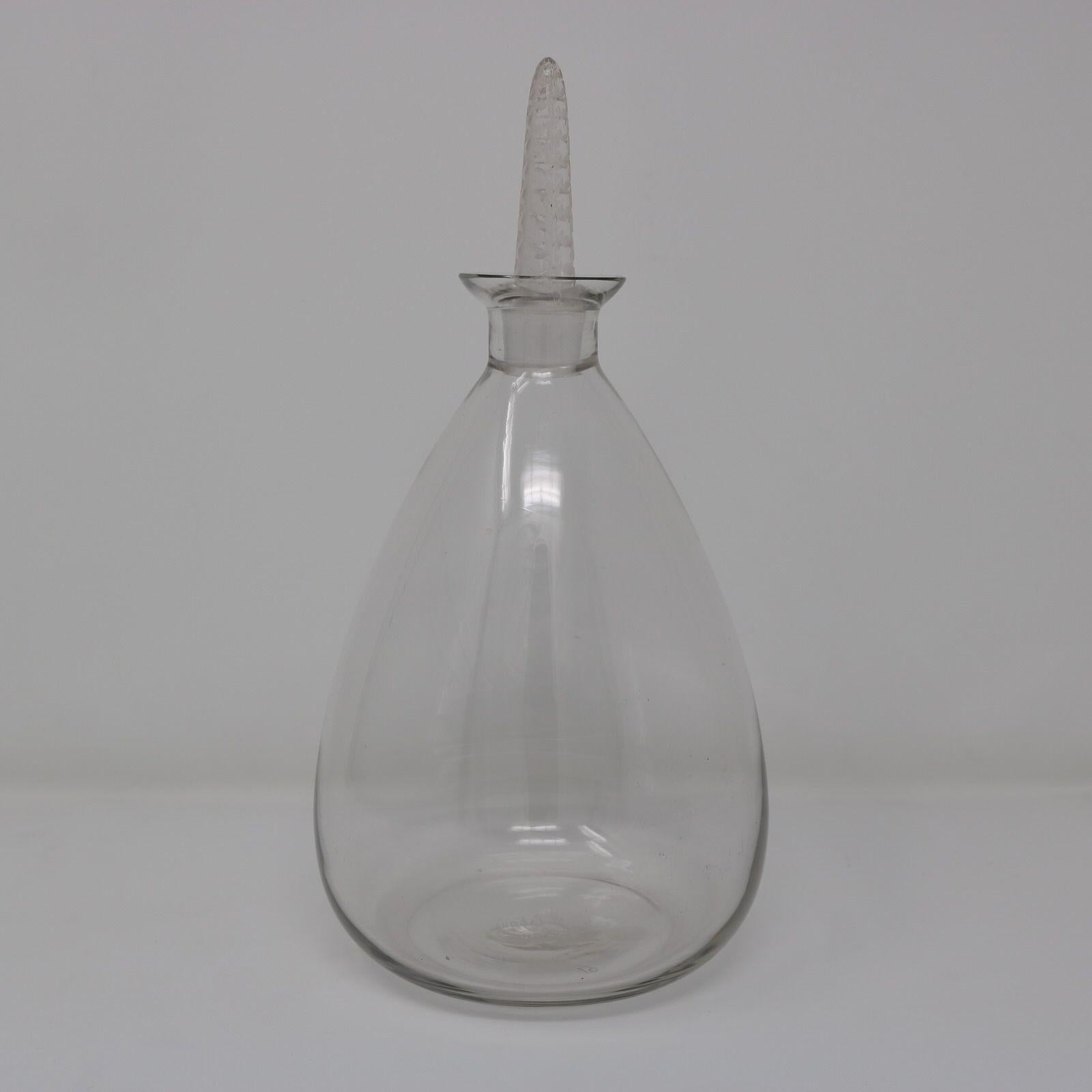 Rene Lalique clear glass 'Dornach' decanter. Has a bulbous shaped bottle. The clear and frosted glass stopper has a geometric pattern of leaves running up it. Inscribed makers mark, 'R Lalique France' and '19' to the base. Book reference: 'R.