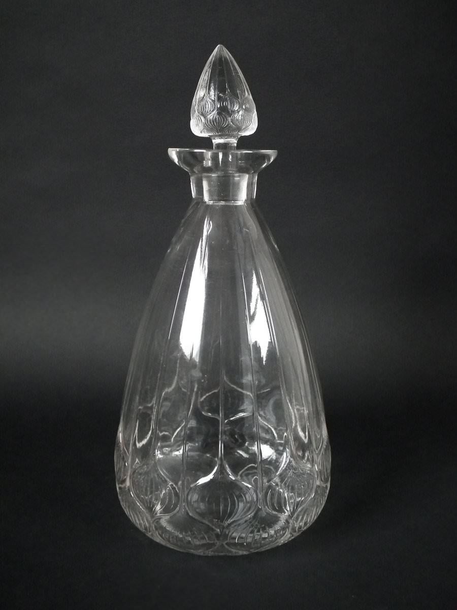 Rene Lalique clear glass 'Haarlem' decanter and six glasses. This pattern features a mosaic of bulbs. Engraved makers marks, 'R Lalique' and 'No.4514'. Molded, 'FRANCE'. Book reference: Marcilhac 4510.