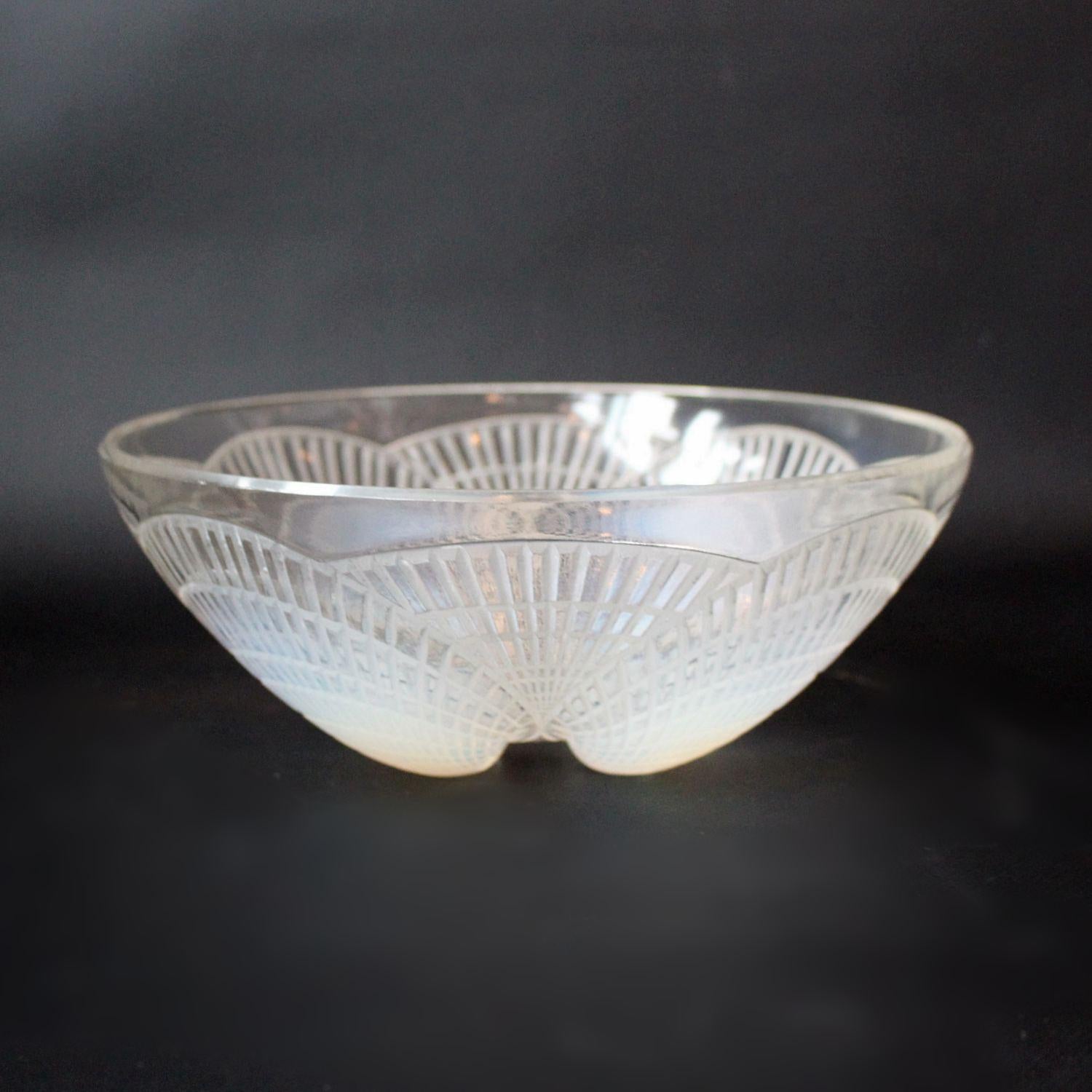 Coupe Coquilles no. 1, an Art Deco, blue opalescent glass bowl. Covered with raised, geometric motif of scallop shells. Model no. 3200. Etched R. Lalique France and numbered to base.
Literature: Marcilhoc, R. Lalique Catalogue Raisonne de L'Oeuvre