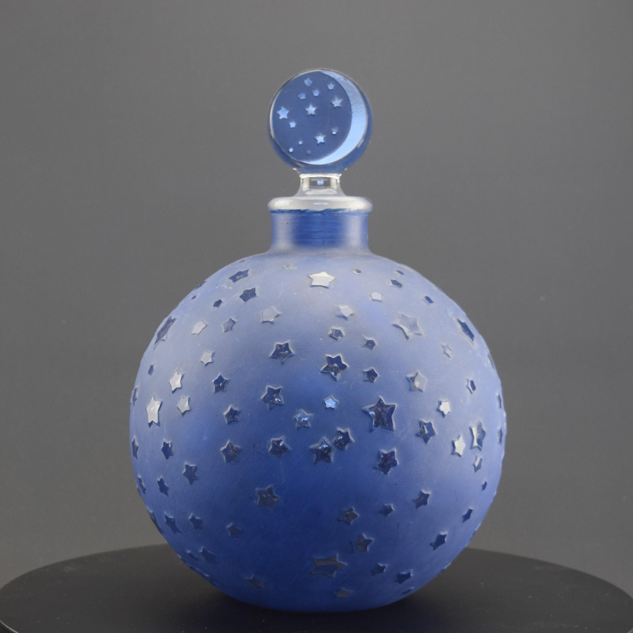 Rene Lalique Dans Le Nuit perfume bottle
Made for Worth
This bottle can be found in three sizes and this is the largest one which is very hard to find 

Introduced in 1924
Marcilhac page ref:952

The condition is very good, the blue enamel is in