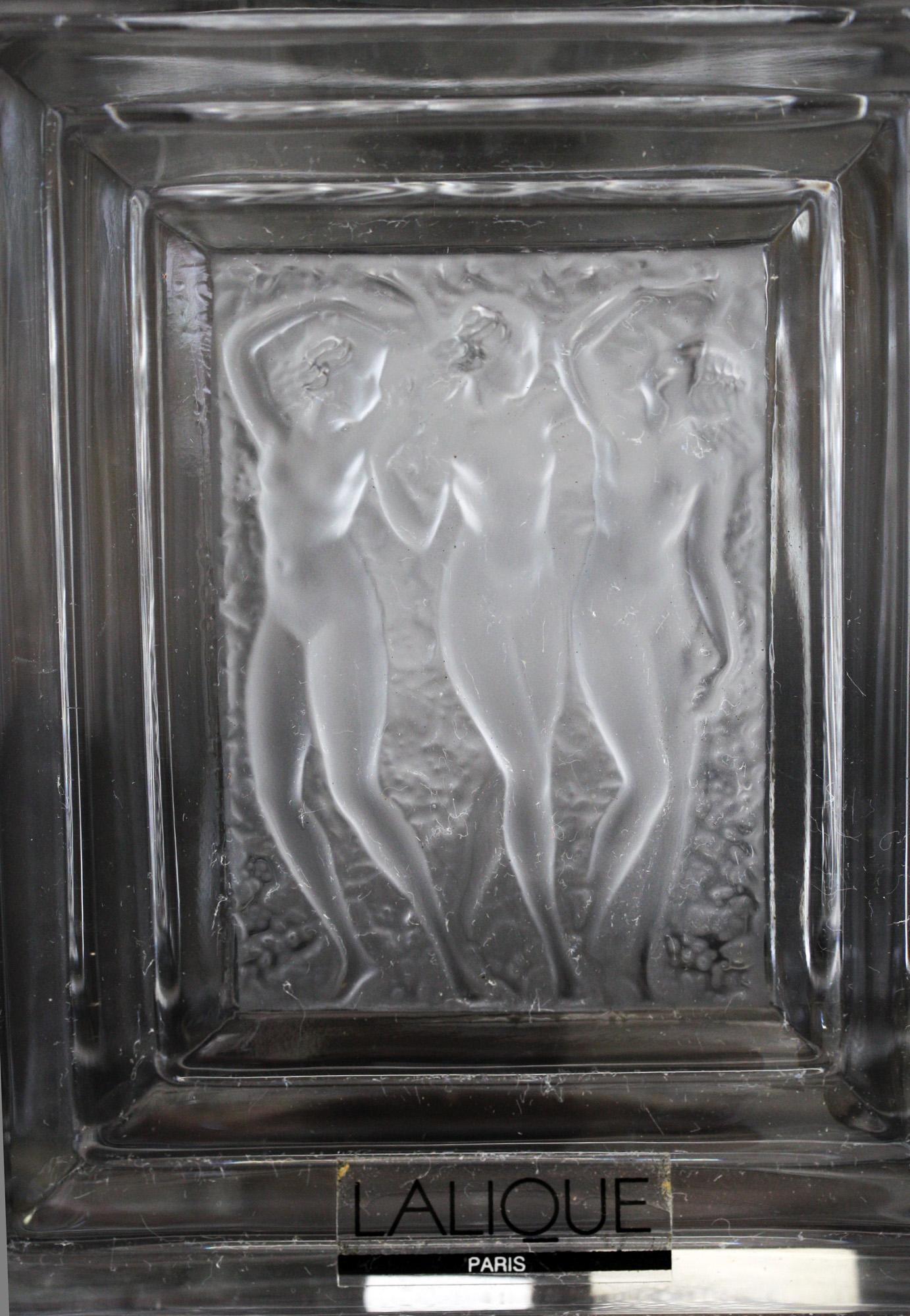 A stunning French Rene Lalique Duncan 2 scent bottle decorated with three frosted dancing nudes in relief dating from the 1970s. The bottle was inspired by American dancer Isadora Duncan and was made in varying sizes. The rectangular shaped bottle