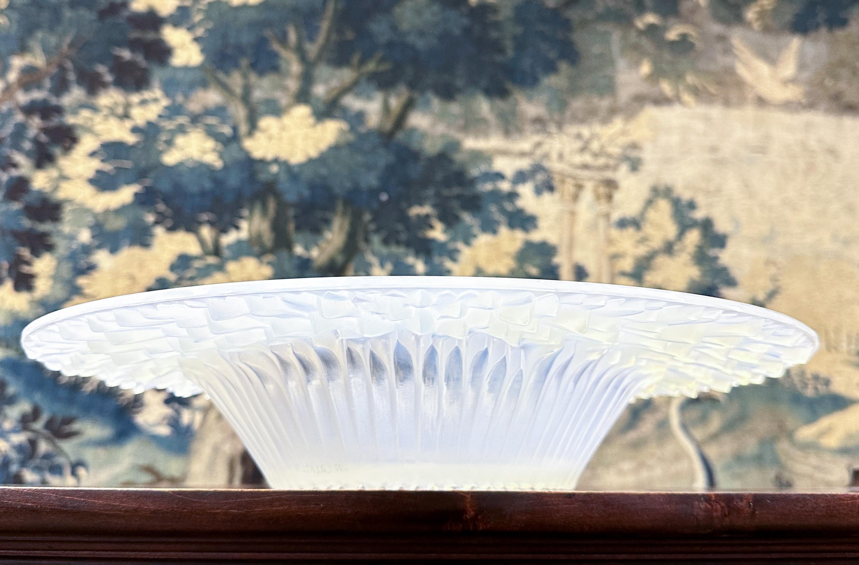 Large molded glass bowl, Flora Bella model. Model created in 1930 by René Lalique after a drawing by his daughter Suzanne. Opalescent white speckled transparent glass bowl. Signature in the hollow decoration. Very beautiful decoration of flower