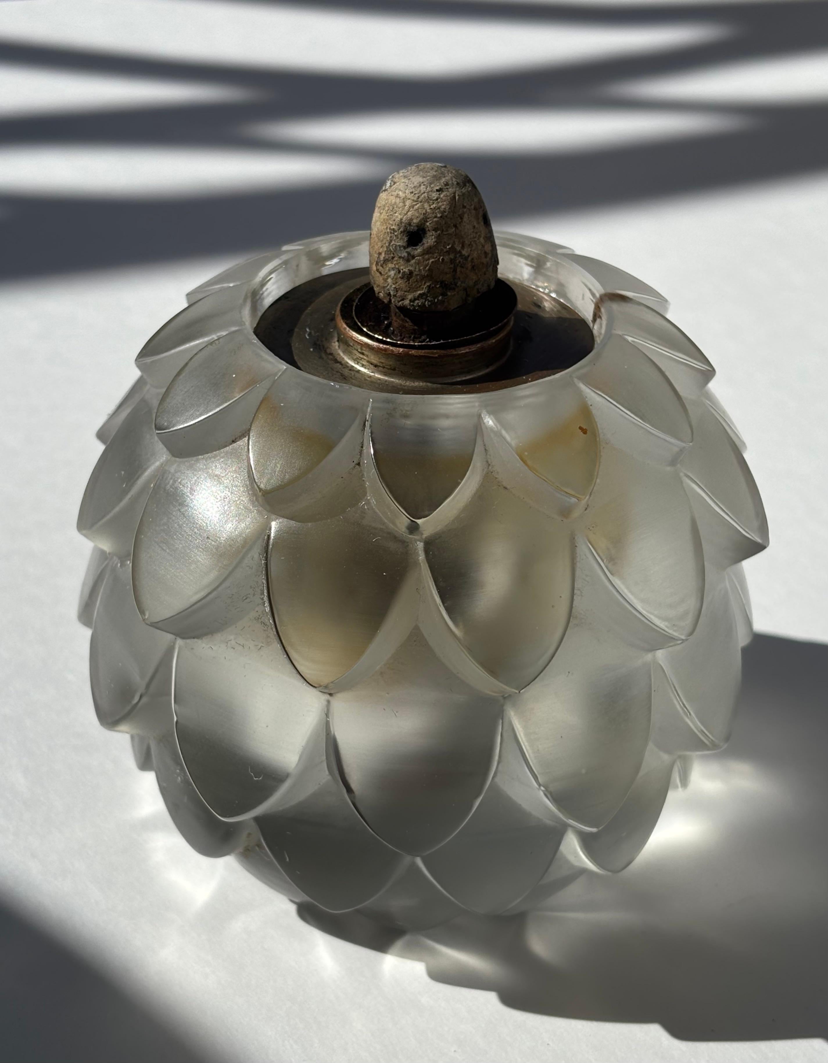 Very nice burner by Berger , designed for the well known jeweler /designer Rene Lalique, this burner has a vintage wick and flame stopper apparently made of pumice .Molded signature  block R.LALIQUE.