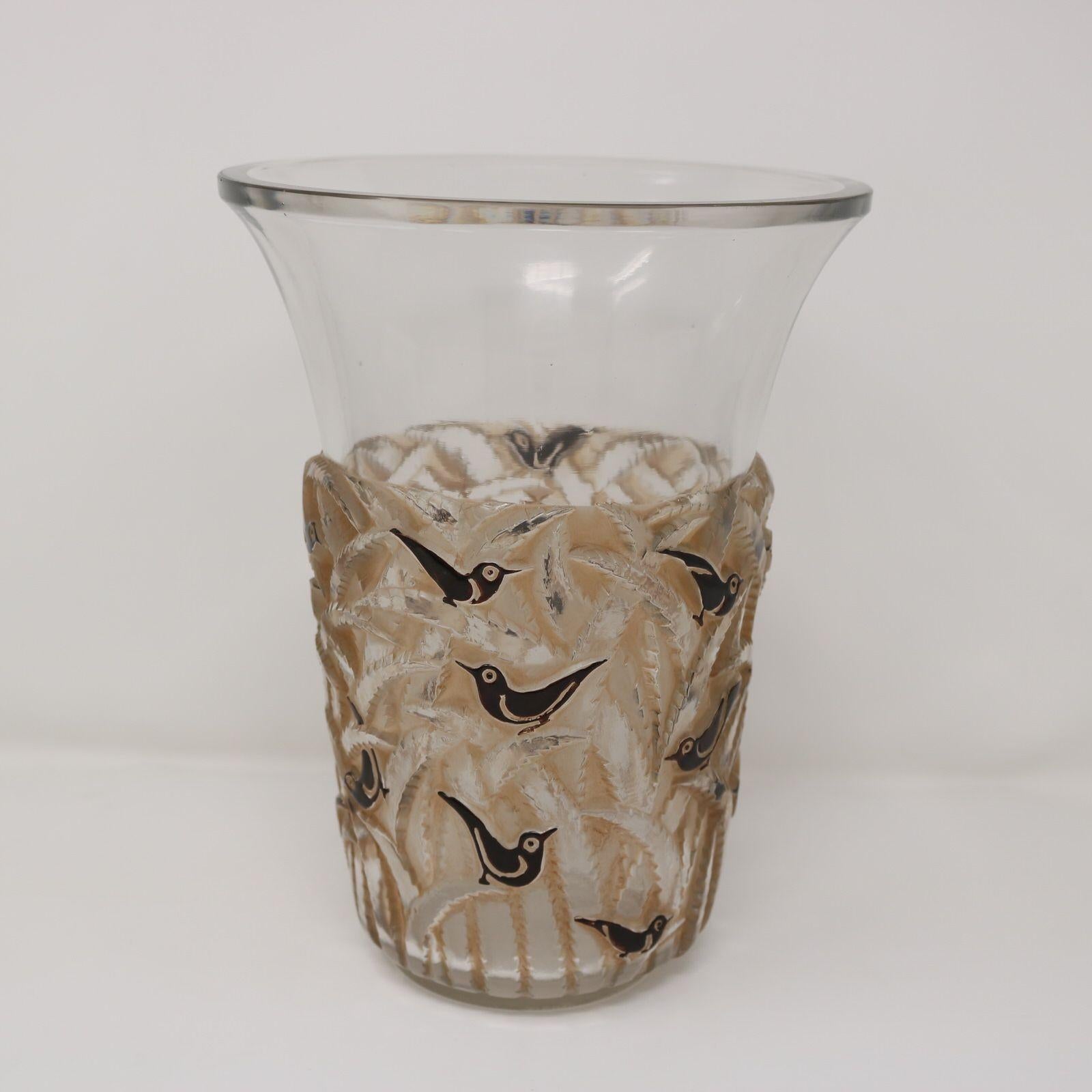 Rene Lalique clear and frosted glass 'Borneo' vase. The pattern features birds perched amongst fern-like foliage. The birds are painted in black enamel and the foliage has sepia staining. Engraved makers mark, 'R Lalique France' to the underside.