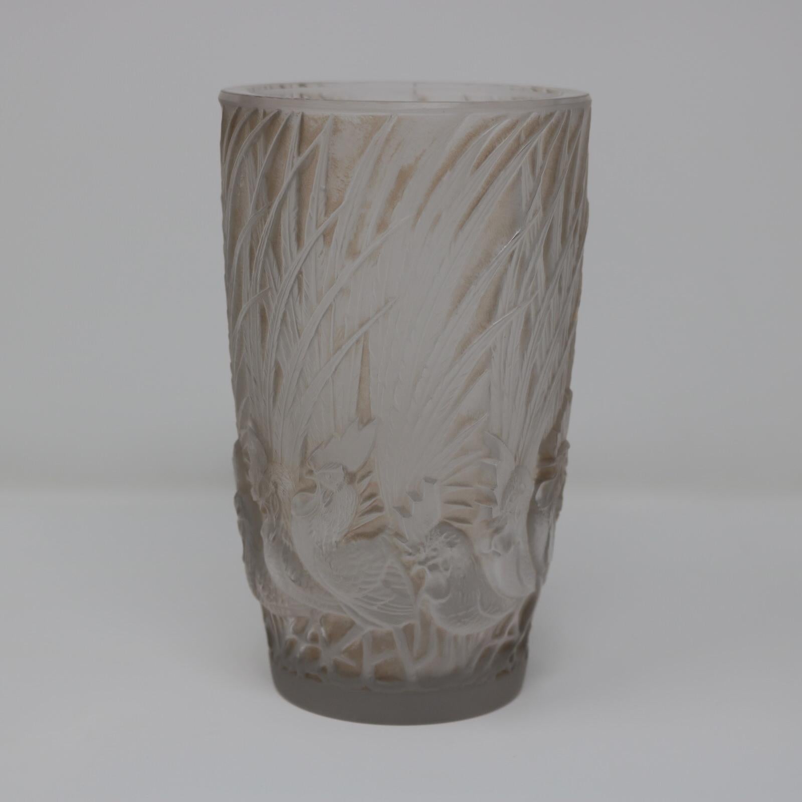 Rene Lalique clear and frosted glass 'Coqs Et Plumes' Vase. Sepia staining to the details. This pattern features cockerels/roosters around the base with their tail feathers rising up the sides of the vase. Wheel cut maker's mark, 'R. LALIQUE'.