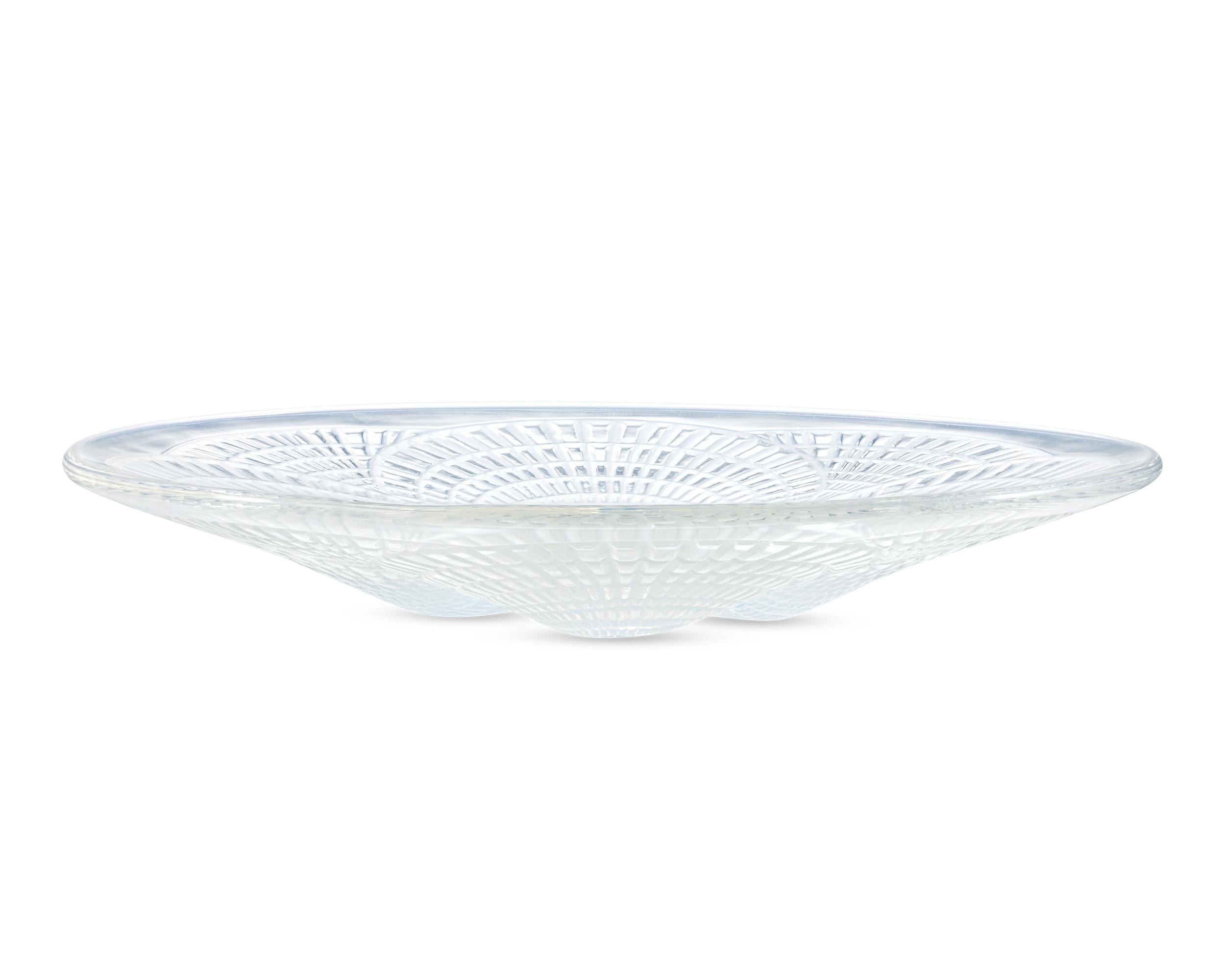 This classic design from René Lalique features four scallop shells. Called the Coquilles motif, it was first designed by René Lalique in 1924. This dish exudes the elegance and artistry of Lalique's most renowned designs.

Lalique remains one of the