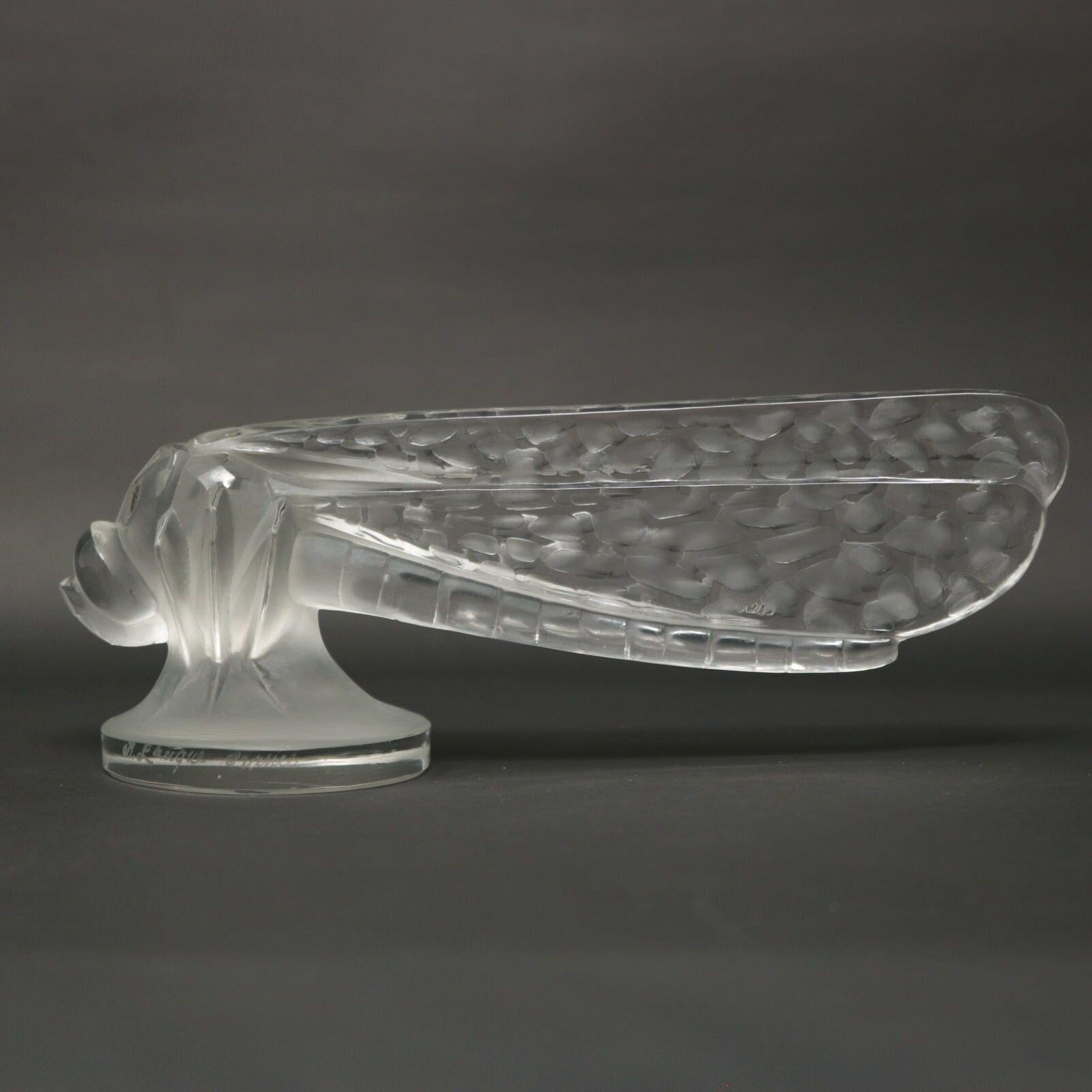 Rene Lalique clear and frosted glass 'Petite Libellule' car mascot (radiator cap). Features a dragonfly sitting with wings closed. Engraved makers mark, 'R Lalique France' to the side rim of the base. Moulded, 'LALIQUE' to the wing. Book reference:
