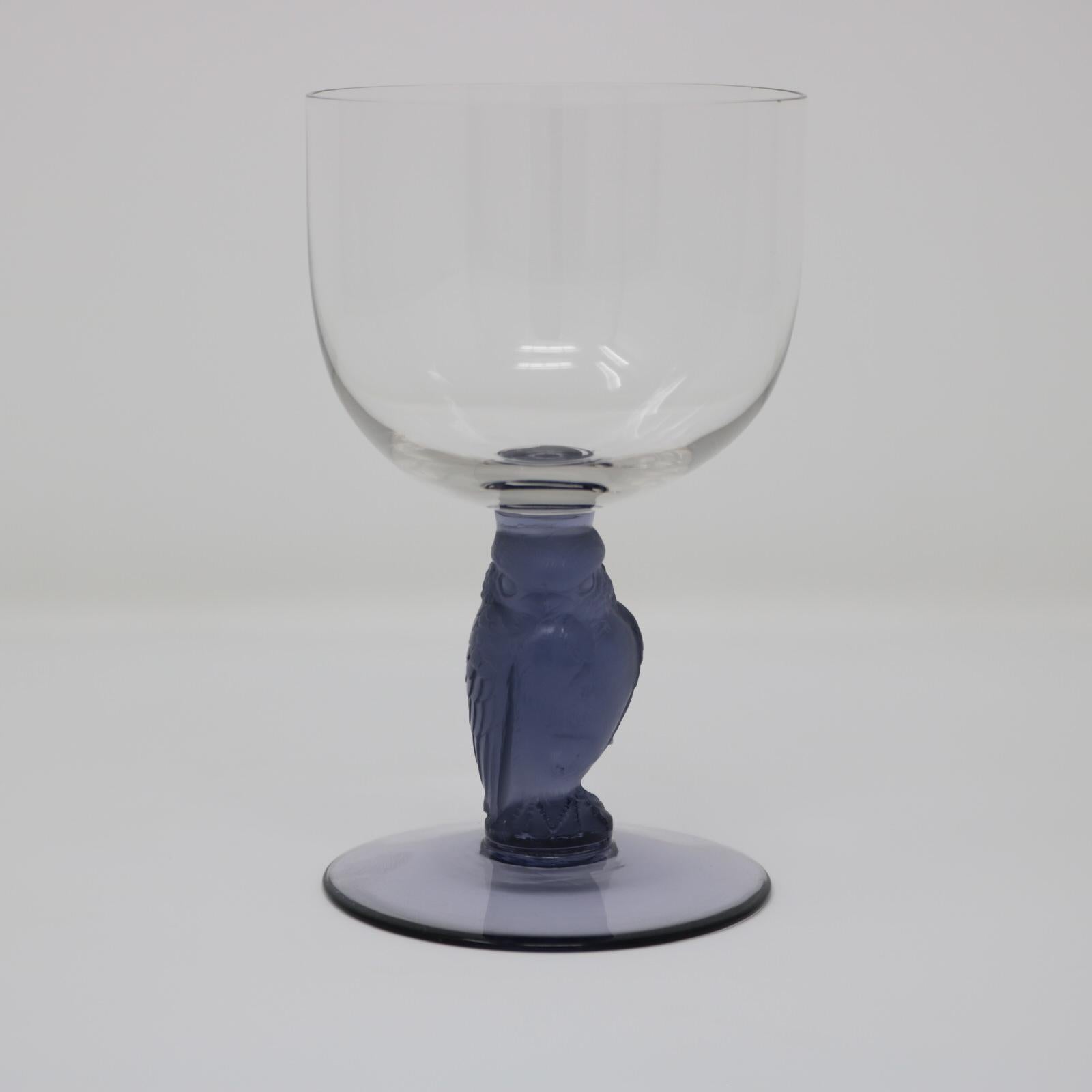 Rene Lalique glass 'Rapace' drinking glass. Clear glass bowl and foot. Blue glass stem modelled in the form of a raptor bird (by direct translation of rapace). Engraved makers mark, 'R Lalique France No.5'. Book reference: Marcilhac page 805,