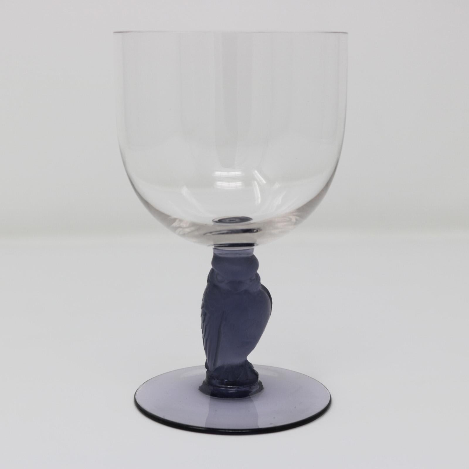 Rene Lalique glass 'Rapace' drinking glass. Clear glass bowl and foot. Blue glass stem modelled in the form of a raptor bird (by direct translation of rapace). Engraved makers mark, 'R Lalique France'. Book reference: Marcilhac page 805, reference N.