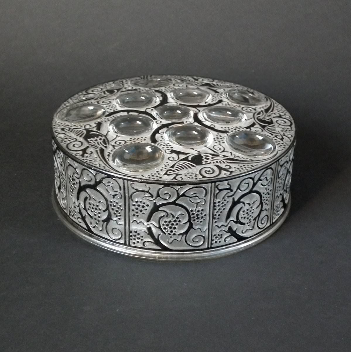 Rene Lalique clear and frosted glass box, with black enameled details. 'Roger' pattern, features stylized fruiting trees and exotic birds. Moulded makers mark, 'Lalique'. Engraved, 'R Lalique France' to underside rim of the lid. Book reference: