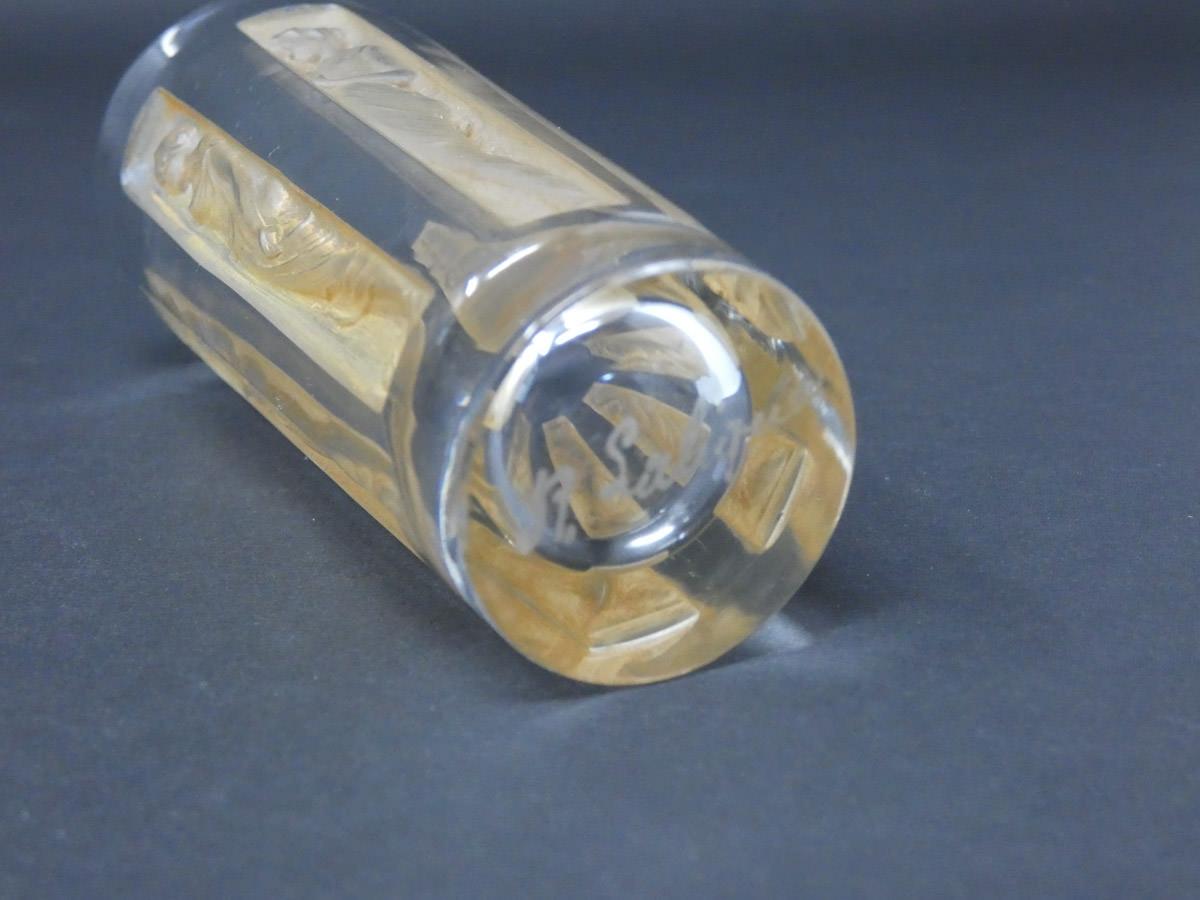 Rene Lalique glass 'Six figurine' Shot glass. Sepia staining to the decoration. Engraved makers mark, 'R Lalique'. Book reference: Marcilhac 3400.