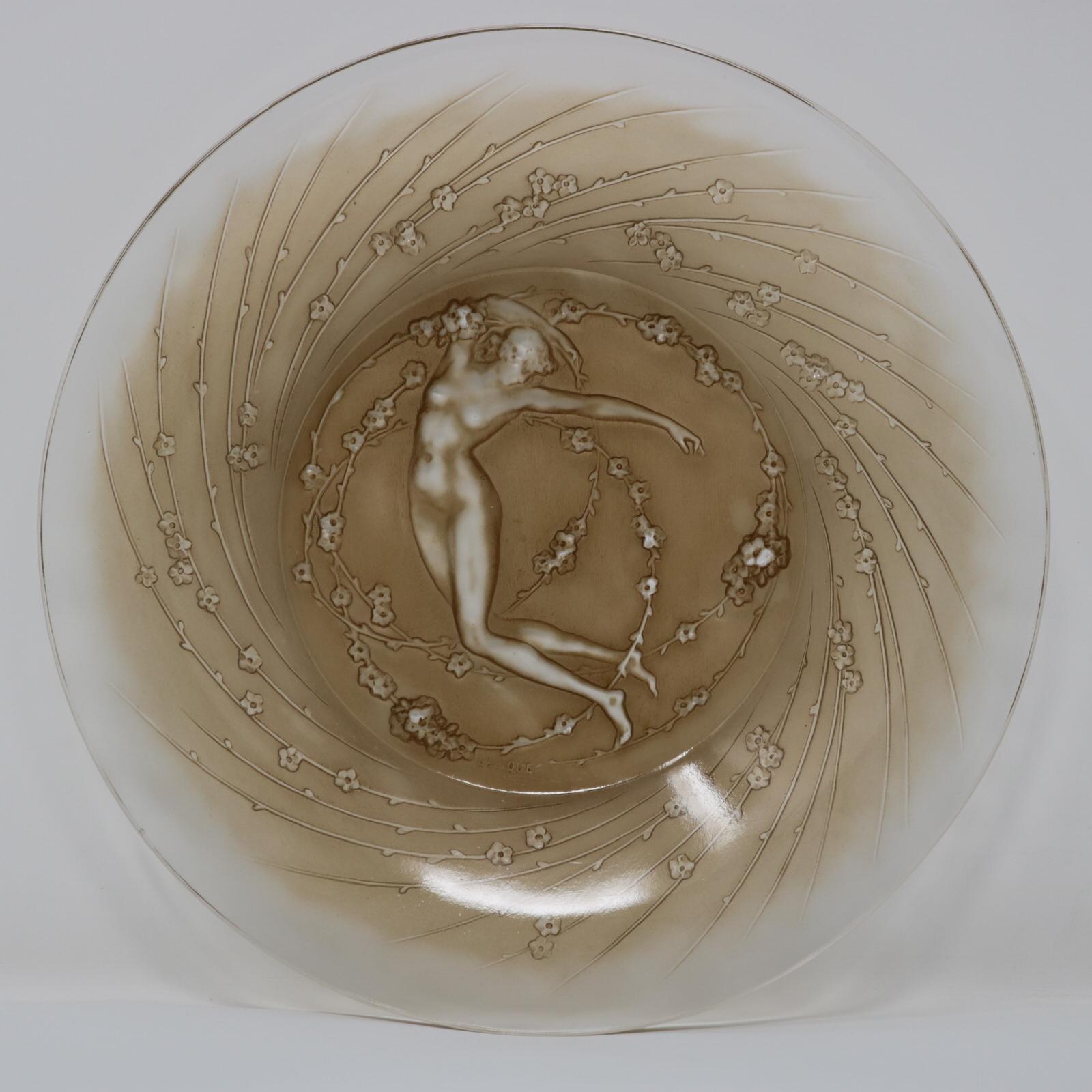Rene Lalique clear and frosted glass, 'Une Figurine et Fleurs' plate. Sepia stained details. This pattern features a naked female figure, surrounded by flowers. Moulded makers mark, 'LALIQUE'. Book reference: Marcilhac 3002.