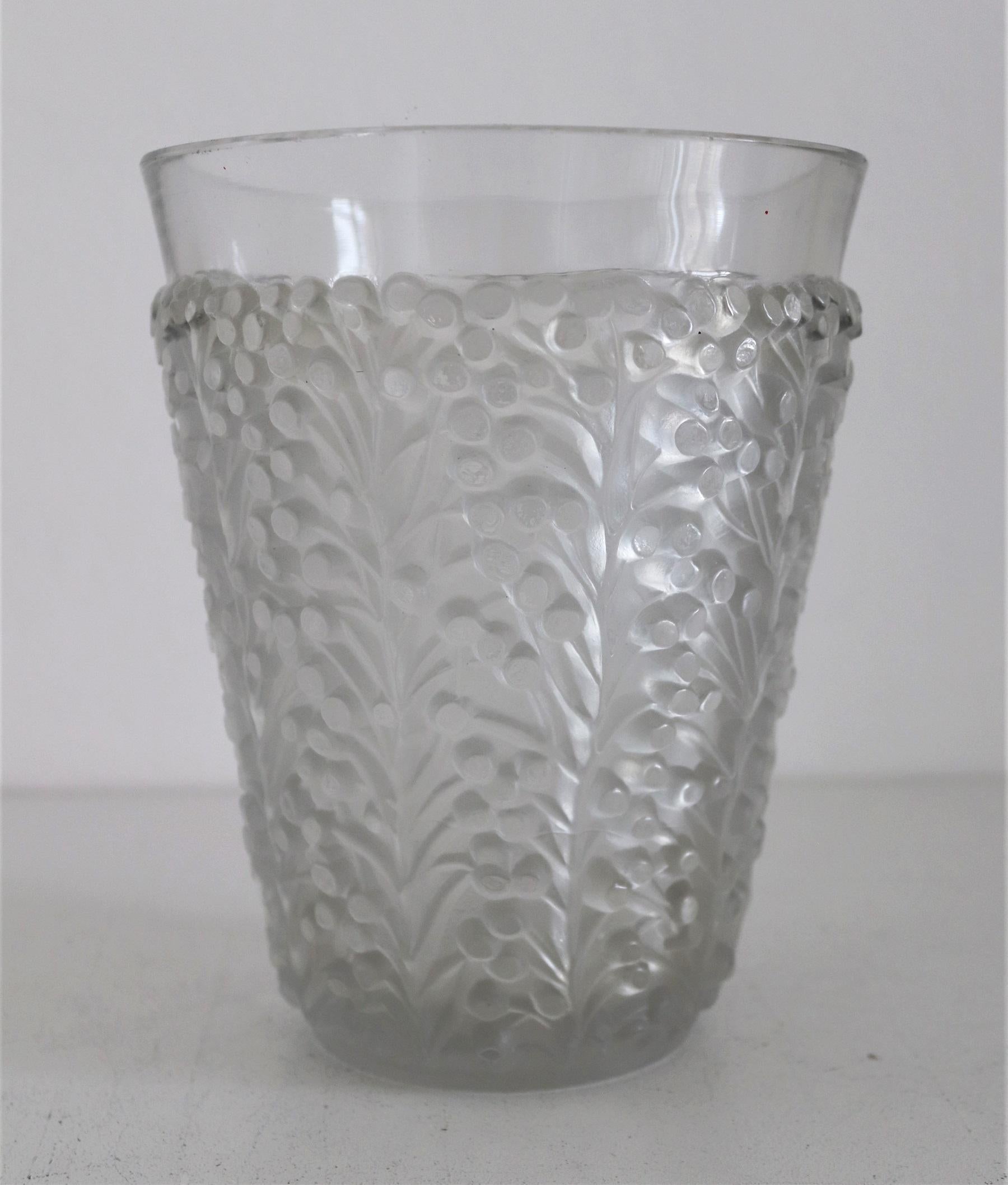 Gorgeous vase made of press-molded frosted and clear glass by René Lalique, France, design circa from 1937.
The decoration of the glass consists of leaf tendrils and small berries, and goes up to approx. 1in (2.5cm) below the edge of the