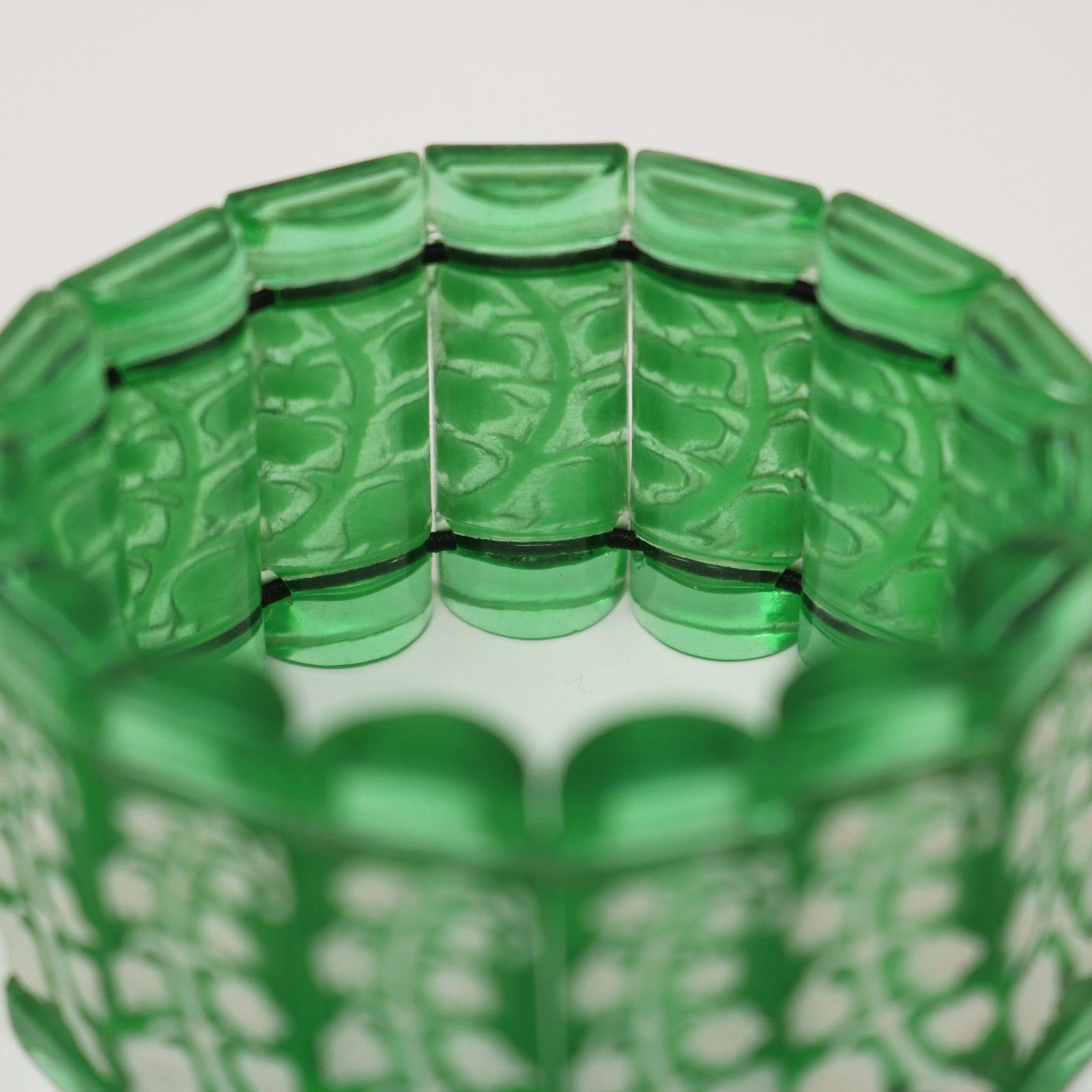 Rene Lalique green glass with white enamel 'Muguet Haut' Bracelet. The bracelet consists of 15 rectangular, cylinder-half shaped tablets, strung together with elastic. Muguet Haut is french for lily of the valley flowers. Each tablet has white
