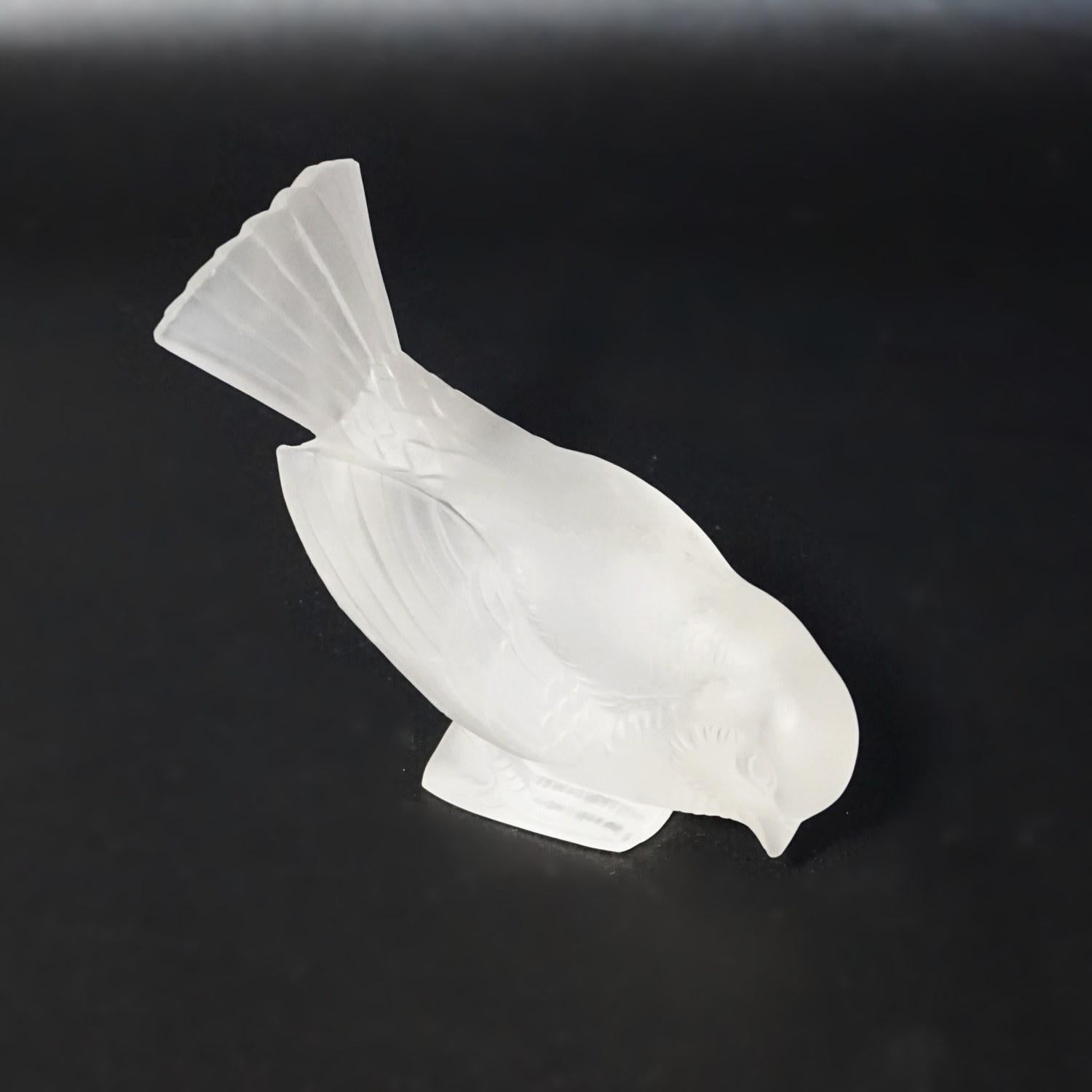 Moineau Hardi, an Art Deco glass bird by René Lalique (1860-1945). A frosted glass figure of a sparrow pecking for food. 

Etch signed R Lalique France to underside

Literature: Marcilhac, R Lalique Catalogue Raisonné de L’Œuvre de Verre p.385.