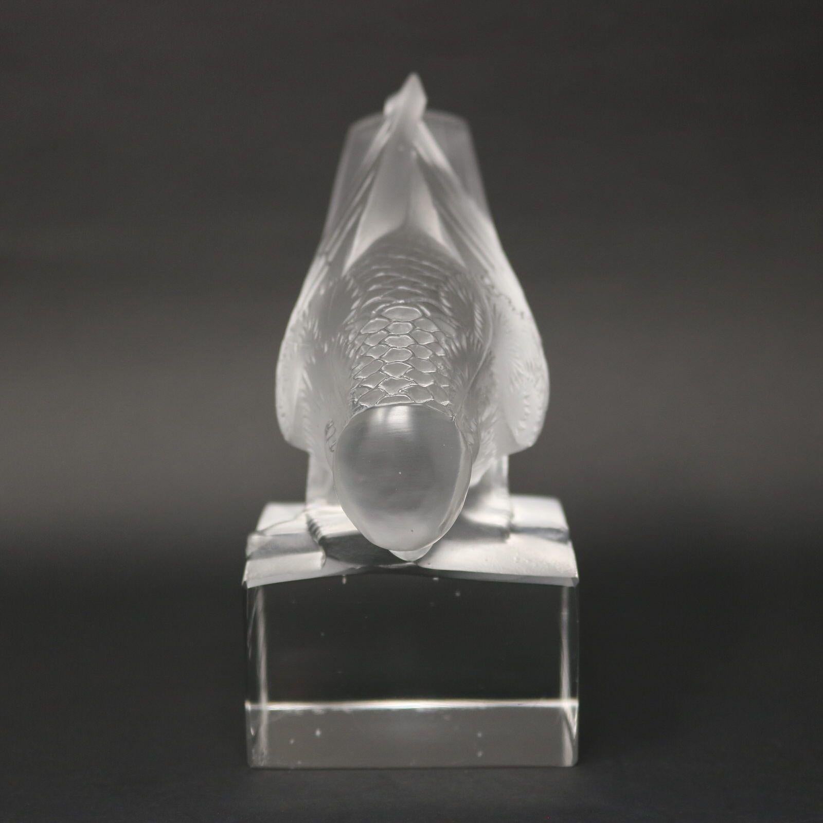 Rene Lalique clear & frosted glass 'Moineau Sur Socle Ailes Fermees' Paperweight. Features a sparrow (wings closed), perched on a pedestal. Engraved makers mark to the underside, 'R. Lalique France'. Moulded makers mark, 'R LALIQUE FRANCE',