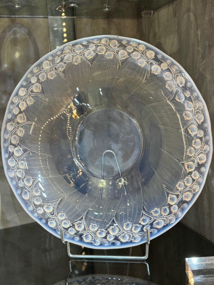 Pressed moulded glass dish, signed on the reverse 
Created in 1931 and discontinued in 1937 
an opalescent and frosted bowl, stencil mark R.Lalique France -- 32cm. diam.