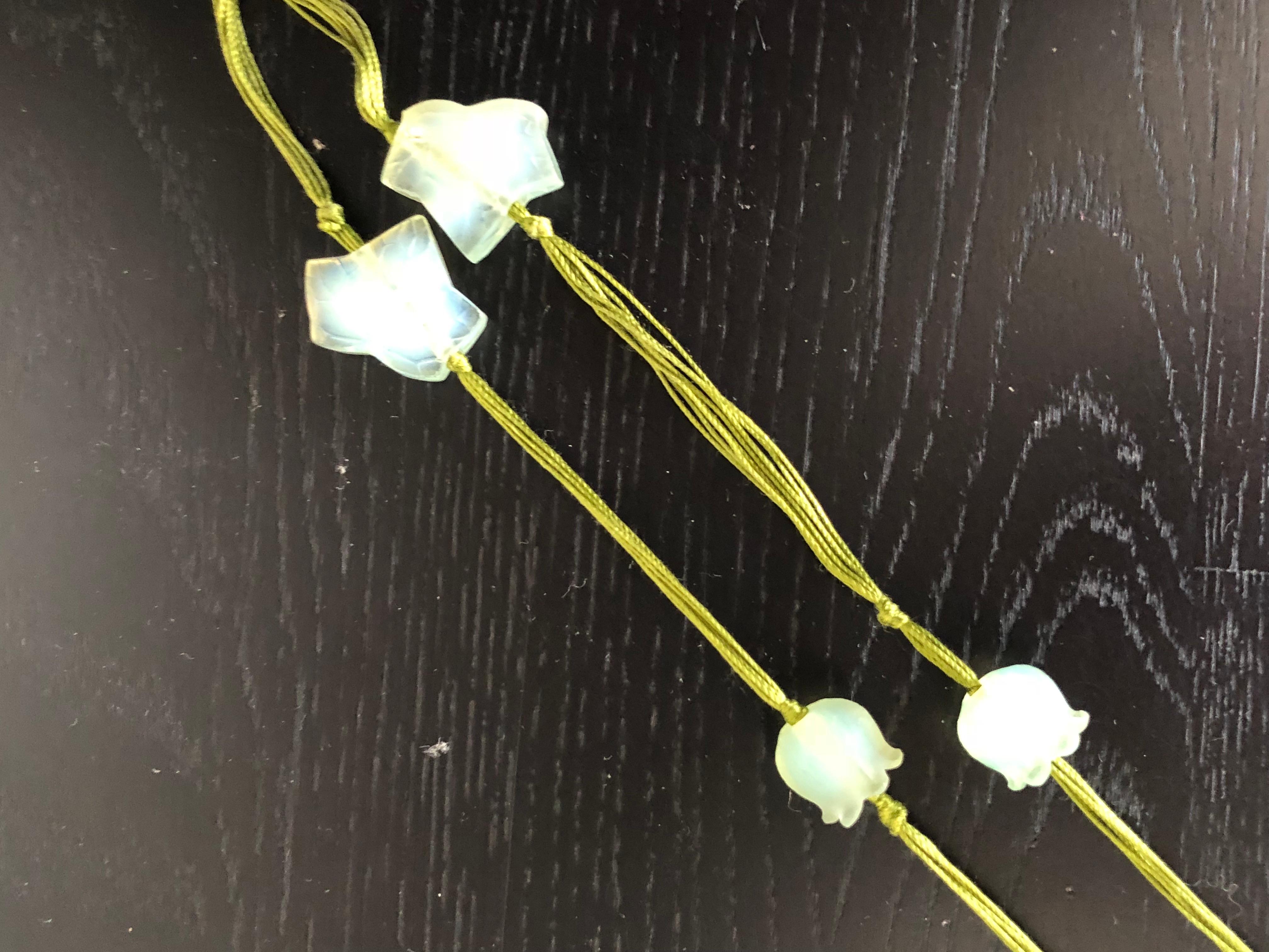 Rene Lalique exceptional and original necklace made with Muguet, Lierre and Marguerite pearls. Muguet and Lierre pearls are made in peppermint opalescent glass and Marguerite is made in amethyst glass. 
Everything is mounted on an original green
