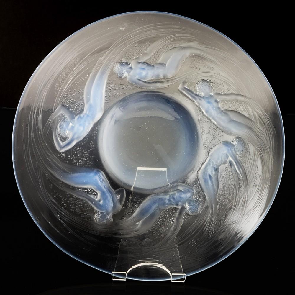 Heading : René Lalique Ondines plate
Date : Designed 1921,Marcilhac 3003
Origin : Wingen-sur-Moder, France
Colour : Clear 
Bowl : Six sea sprites swirl about the centre. Signed R Lalique France in the mould
Pontil : Polished
Glass Type : Lalique