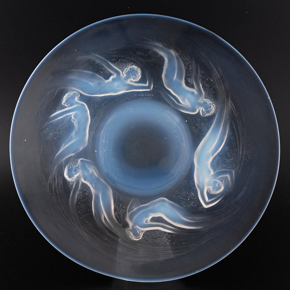Heading : Rene Lalique Ondines plate
Date : Designed 1921
Origin : Wingen-sur-Moder. France
Bowl Features : Six opalescent sea sprites swirl around the centre.
Marks : Stencilled R LALIQUE FRANCE signature along with No. 3003
Type : Lalique