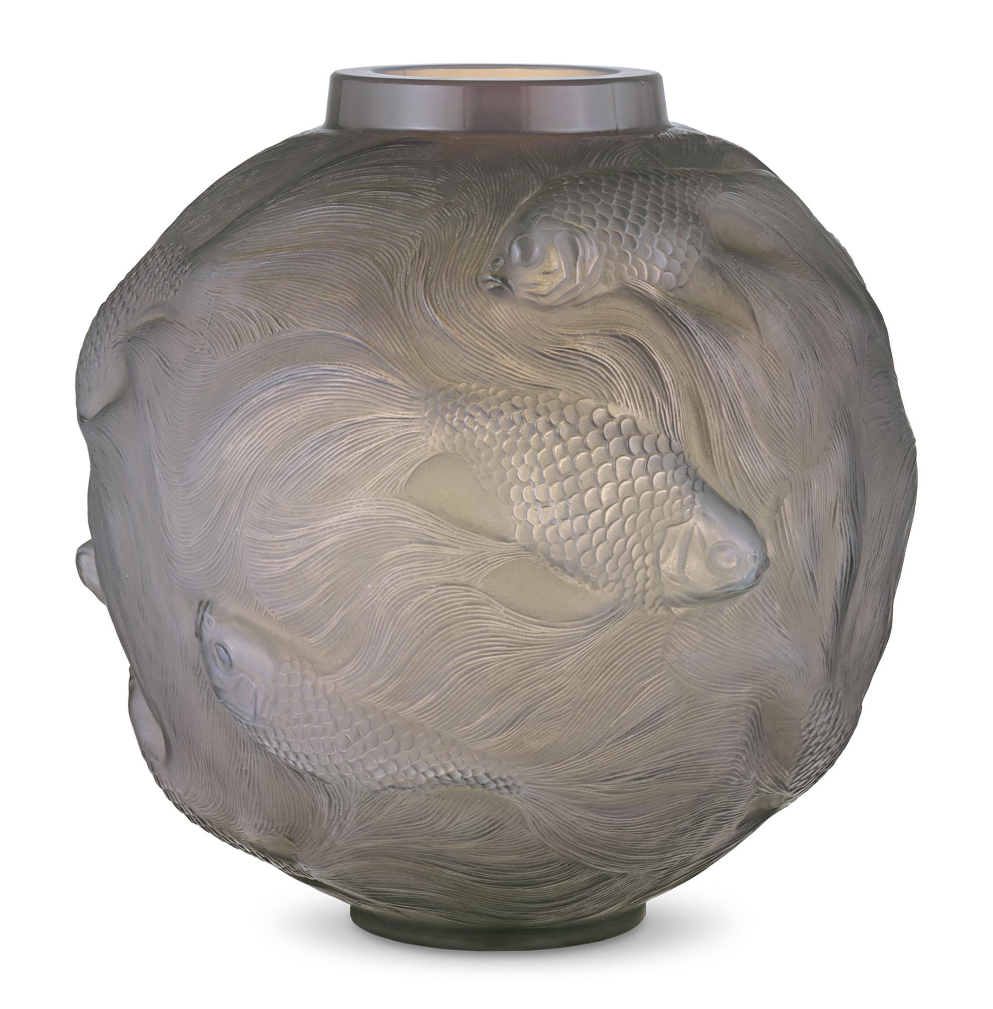 The work of famed French glass master René Lalique, this dynamic vase is crafted in the rare and intricate Formose pattern. Conceived in 1924 during the height of Art Deco, its spherical design is formed from opalescent glass that features elegant